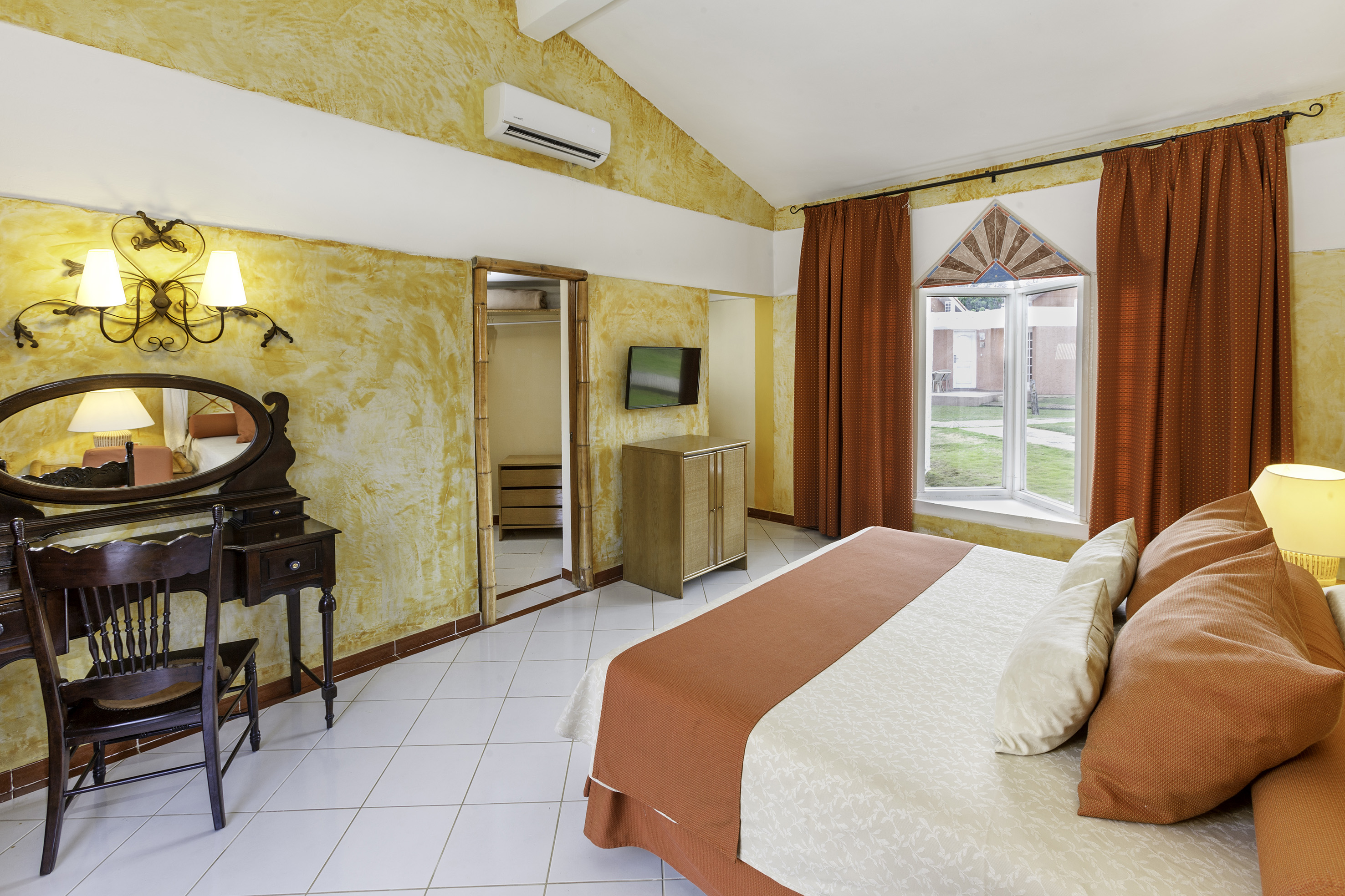 a room with a bed and a mirror