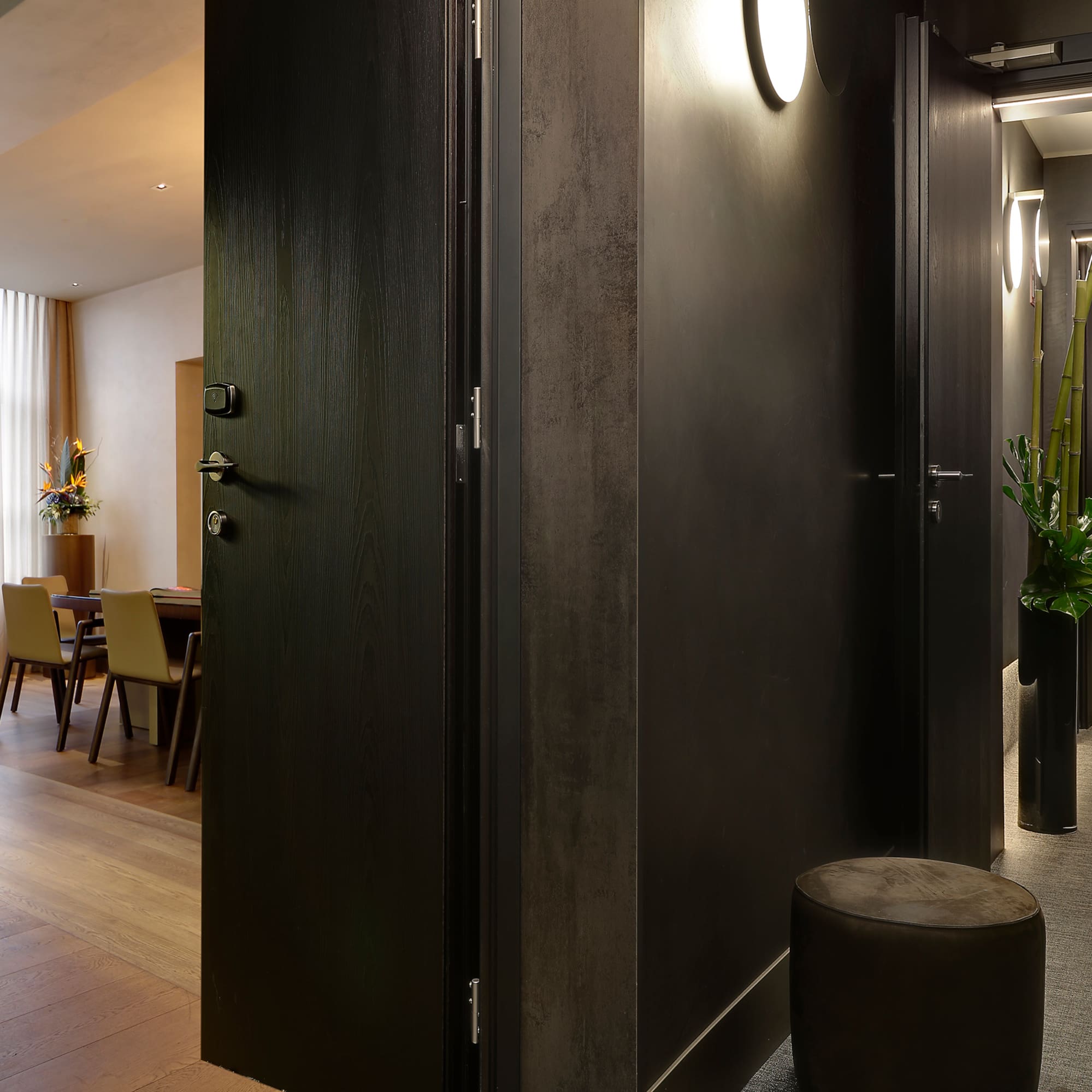 a room with a black door and a black chair