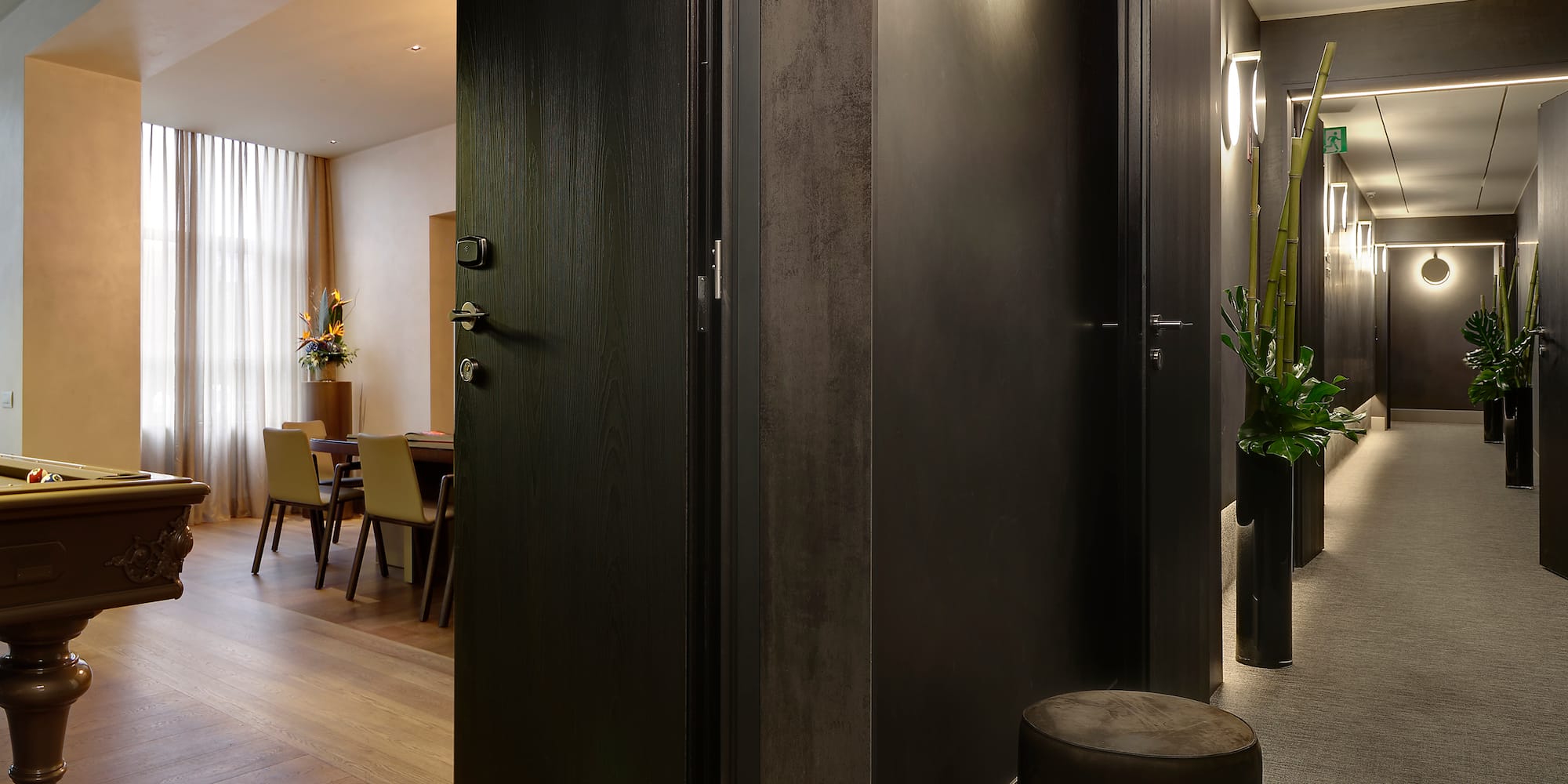 a room with a black door and a black chair