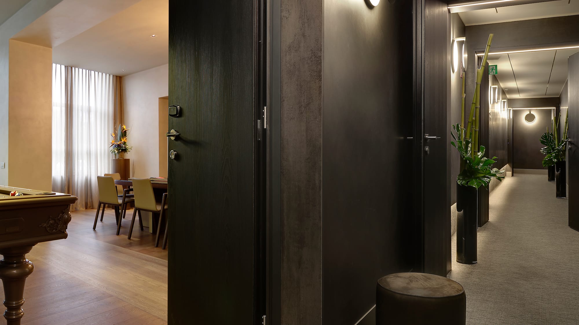 a room with a black door and a black chair