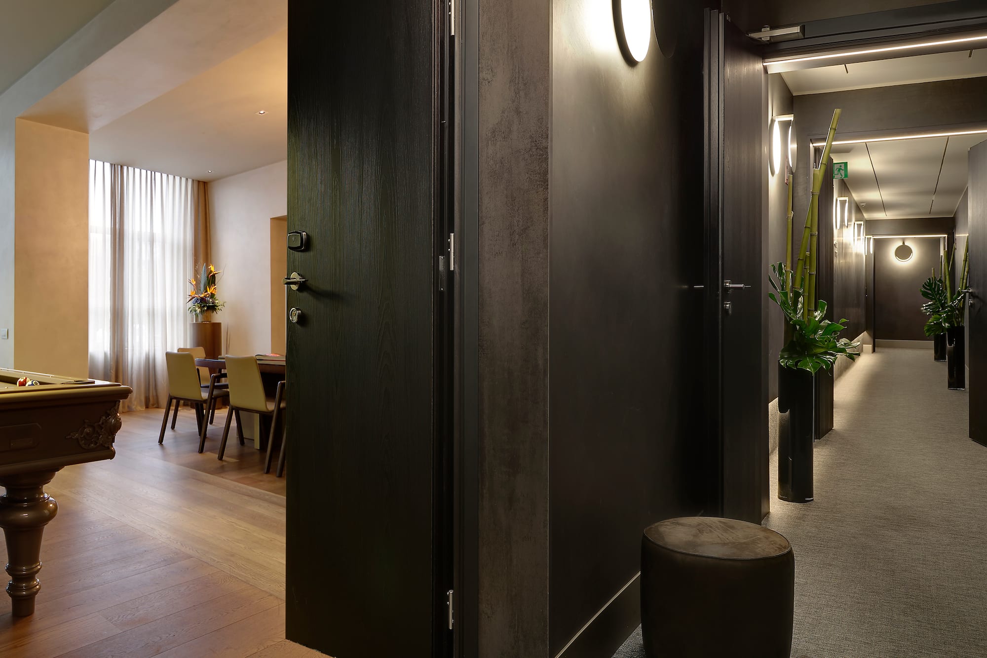 a room with a black door and a black chair