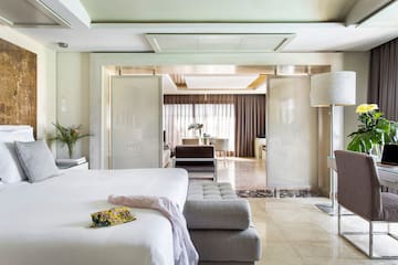 a bedroom with a bed and a couch