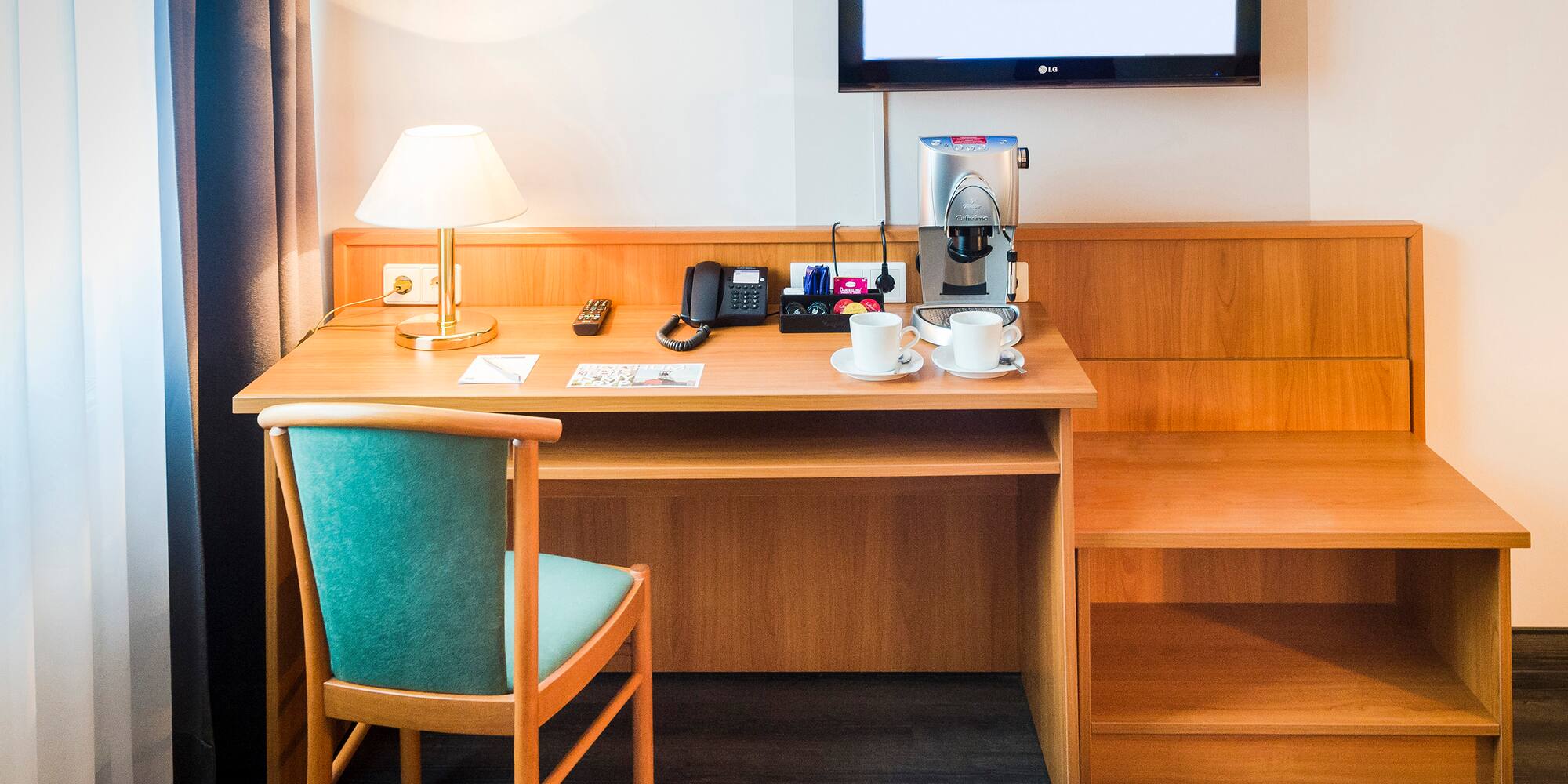 a desk with a tv and a chair