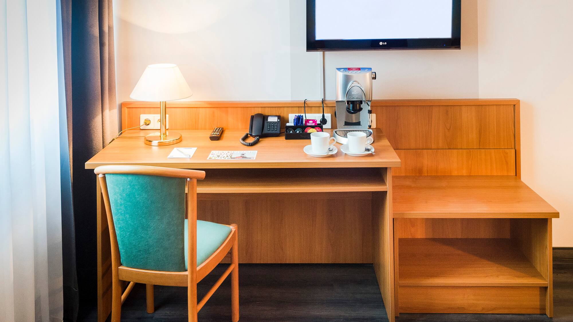 a desk with a tv and a chair
