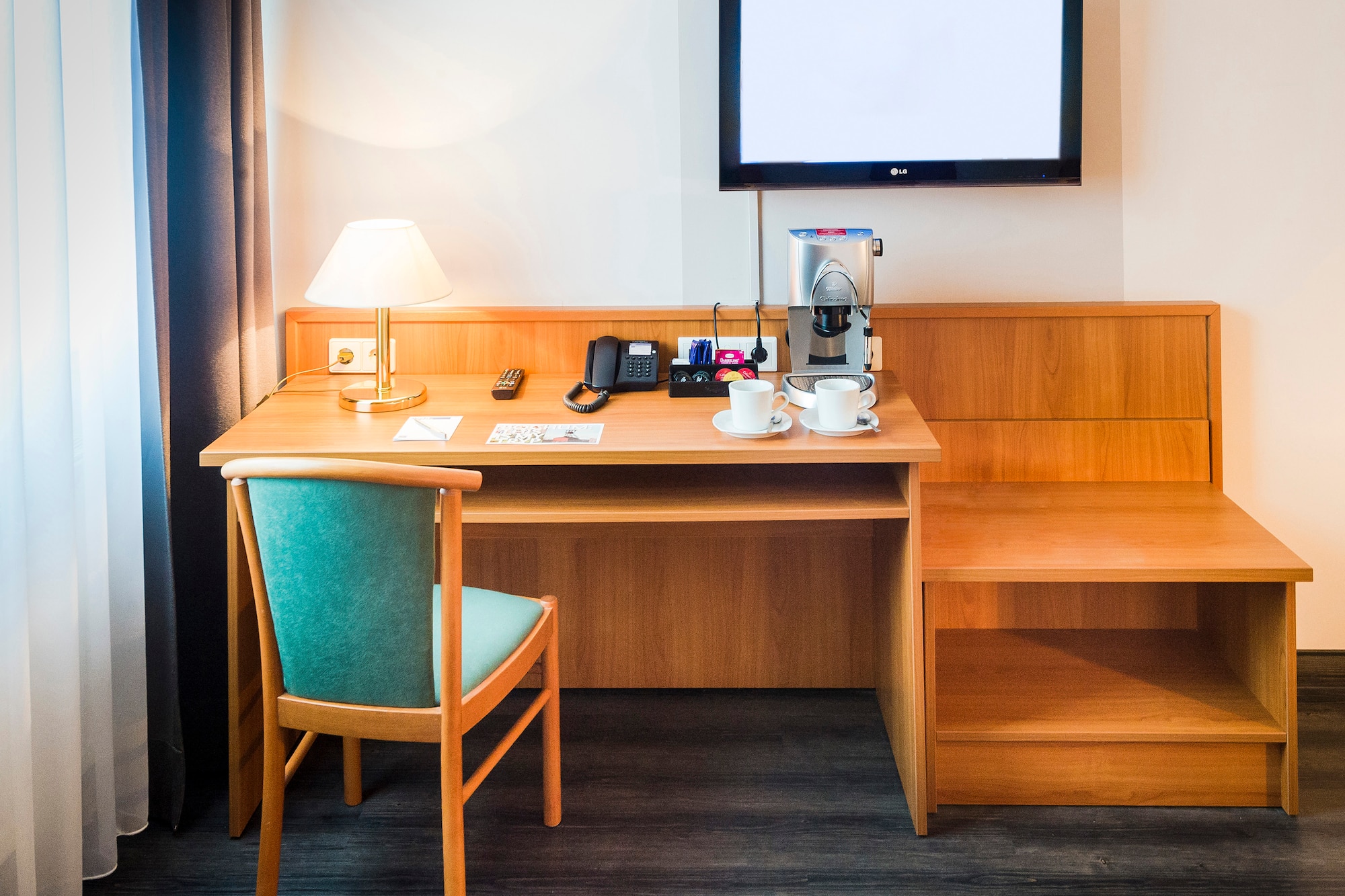 a desk with a tv and a chair