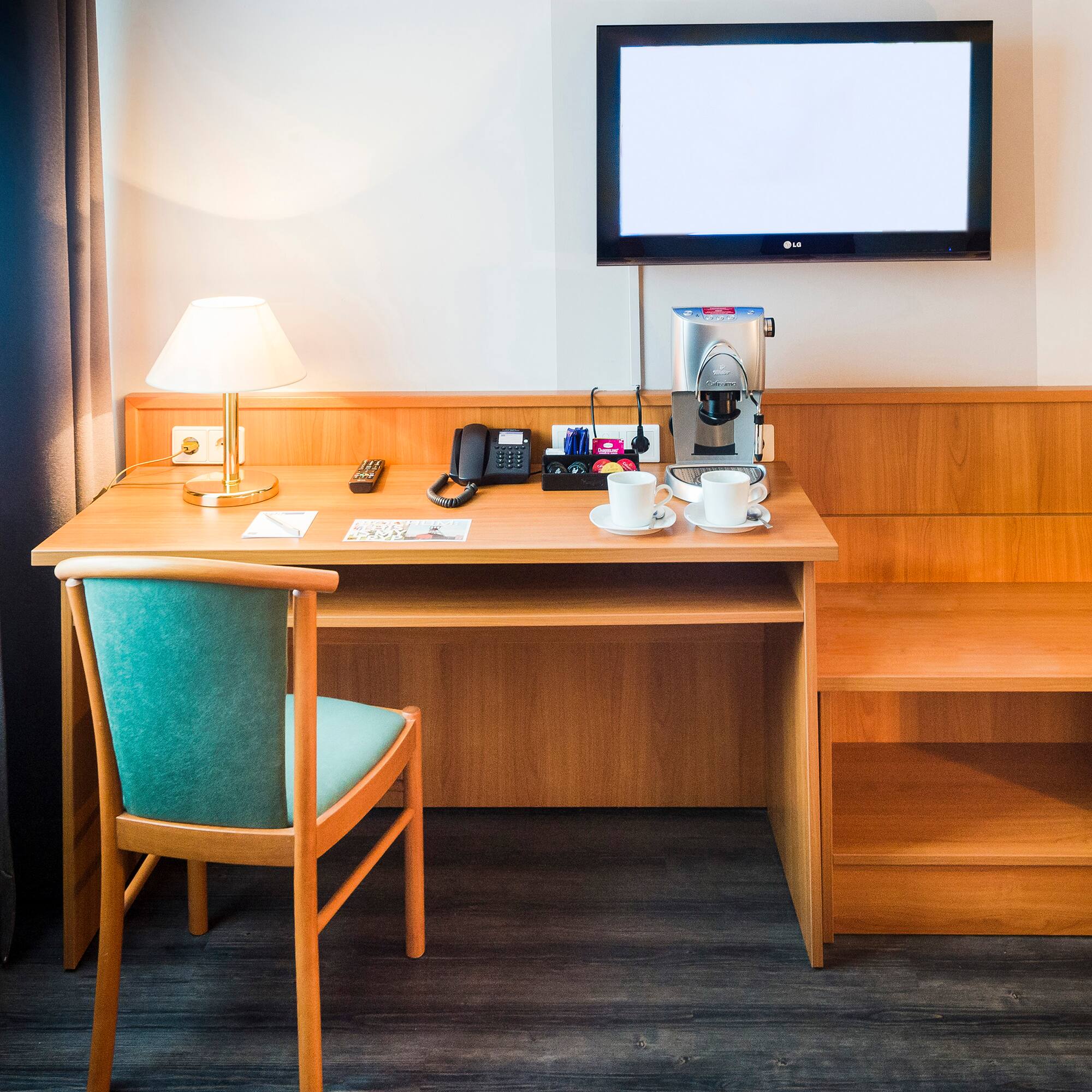 a desk with a tv and a chair