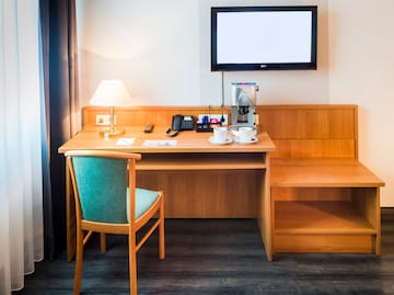 a desk with a tv and a chair