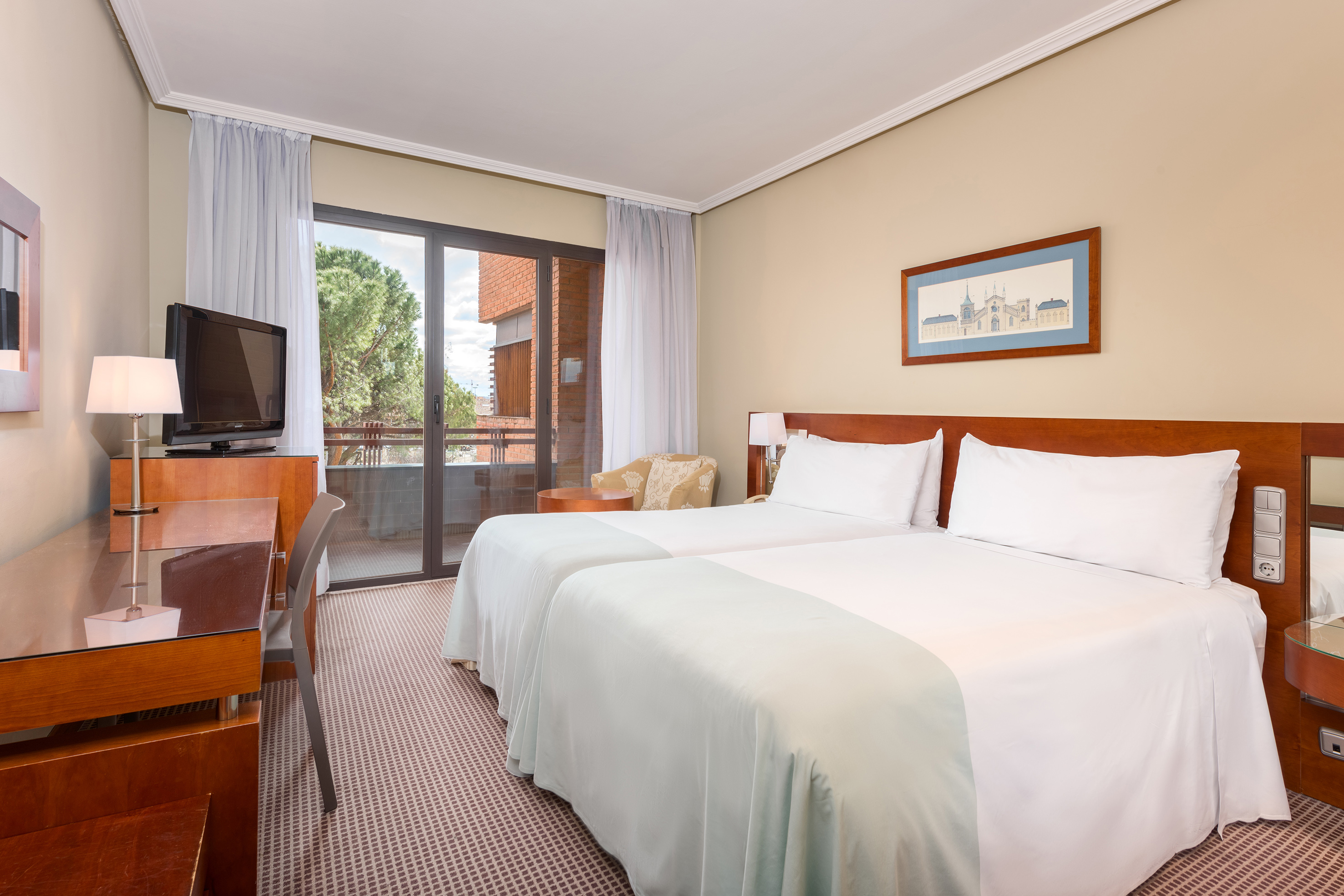 a room with two beds and a television