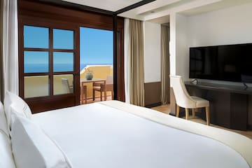 a room with a large bed and a television