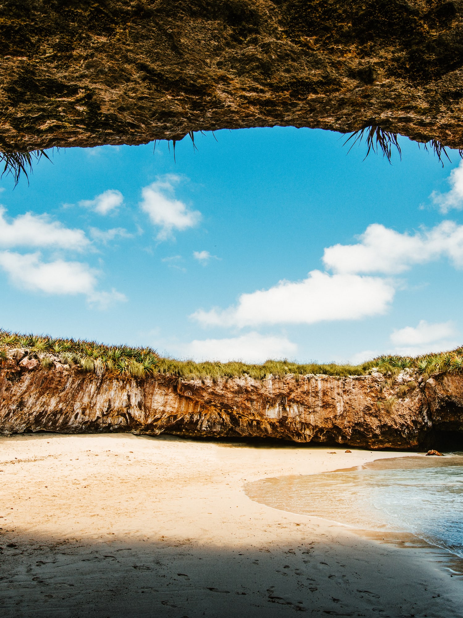 a beach with sand and rocks