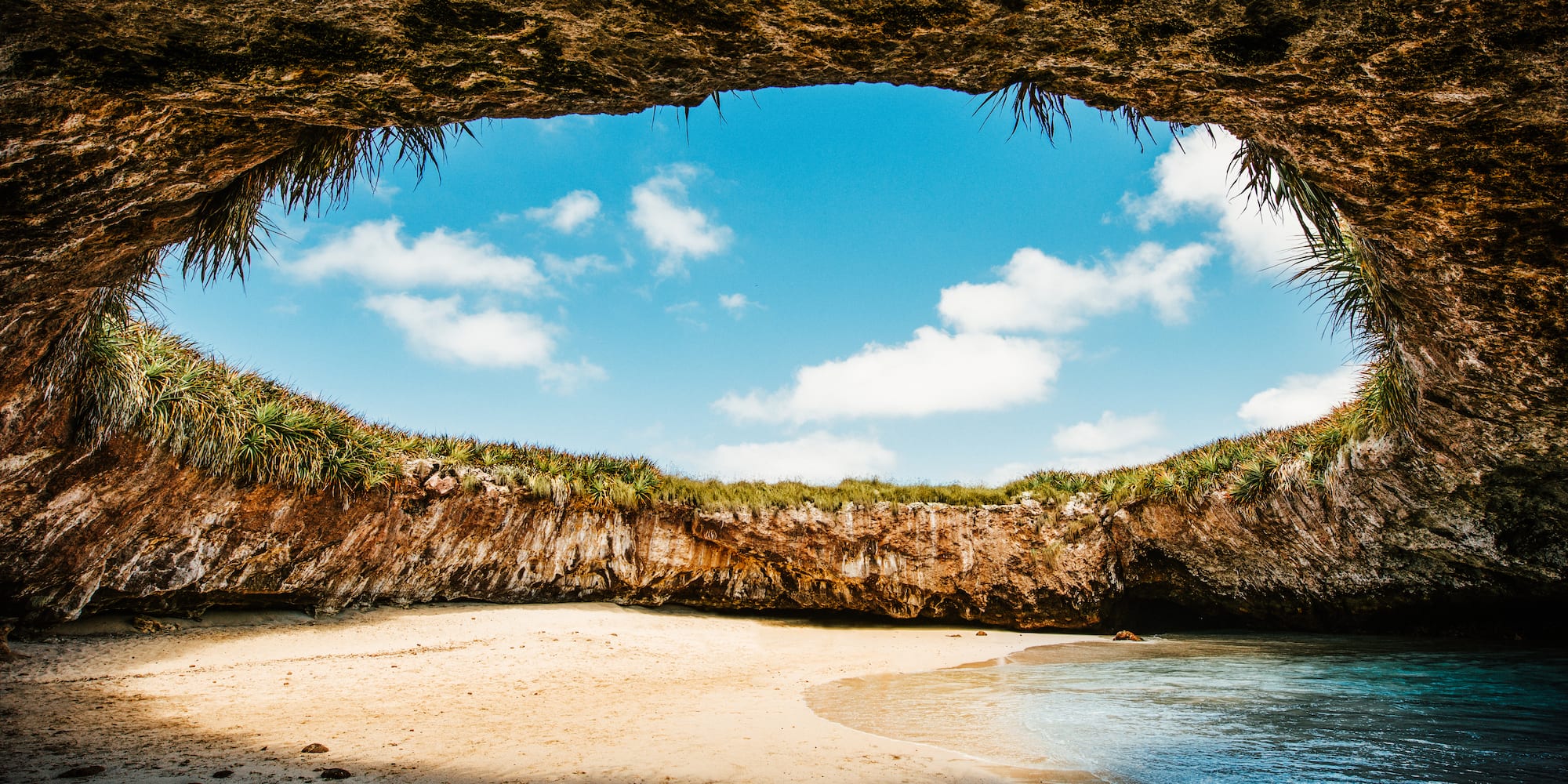 a beach with sand and rocks