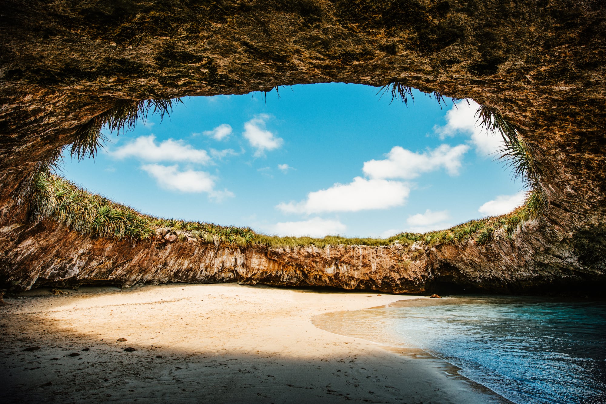 a beach with sand and rocks