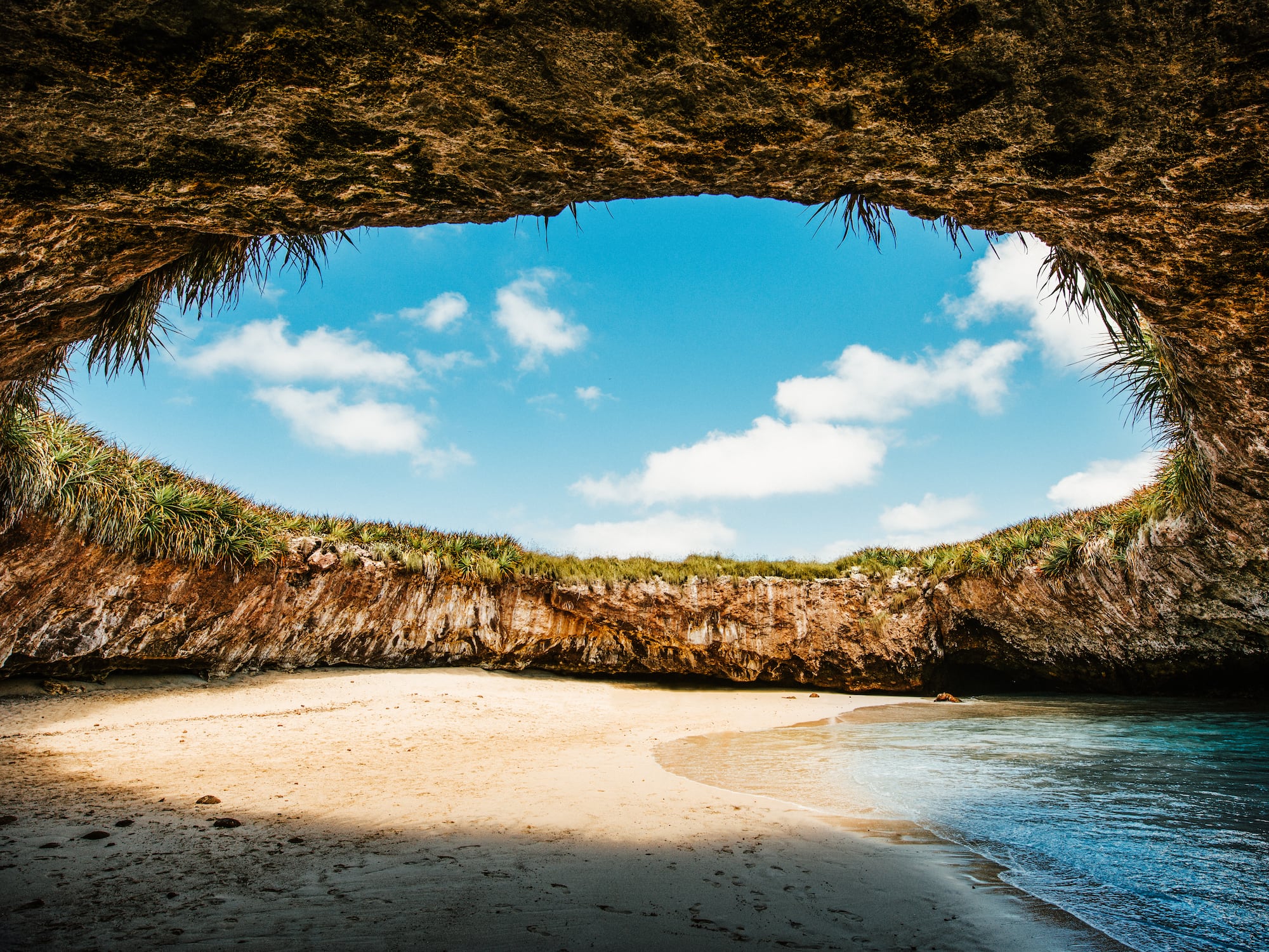a beach with sand and rocks
