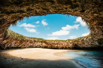 a beach with sand and rocks