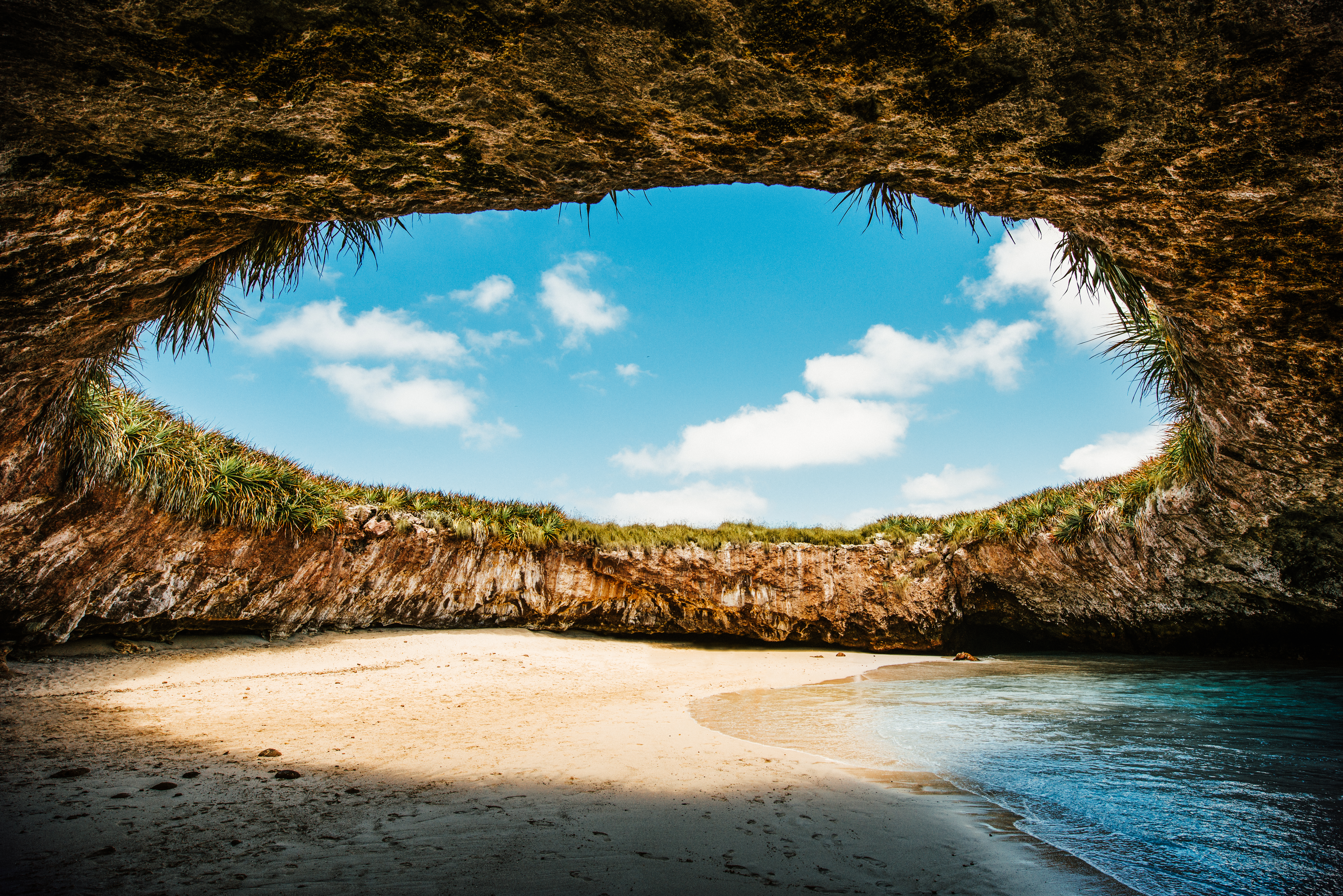 a beach with sand and rocks