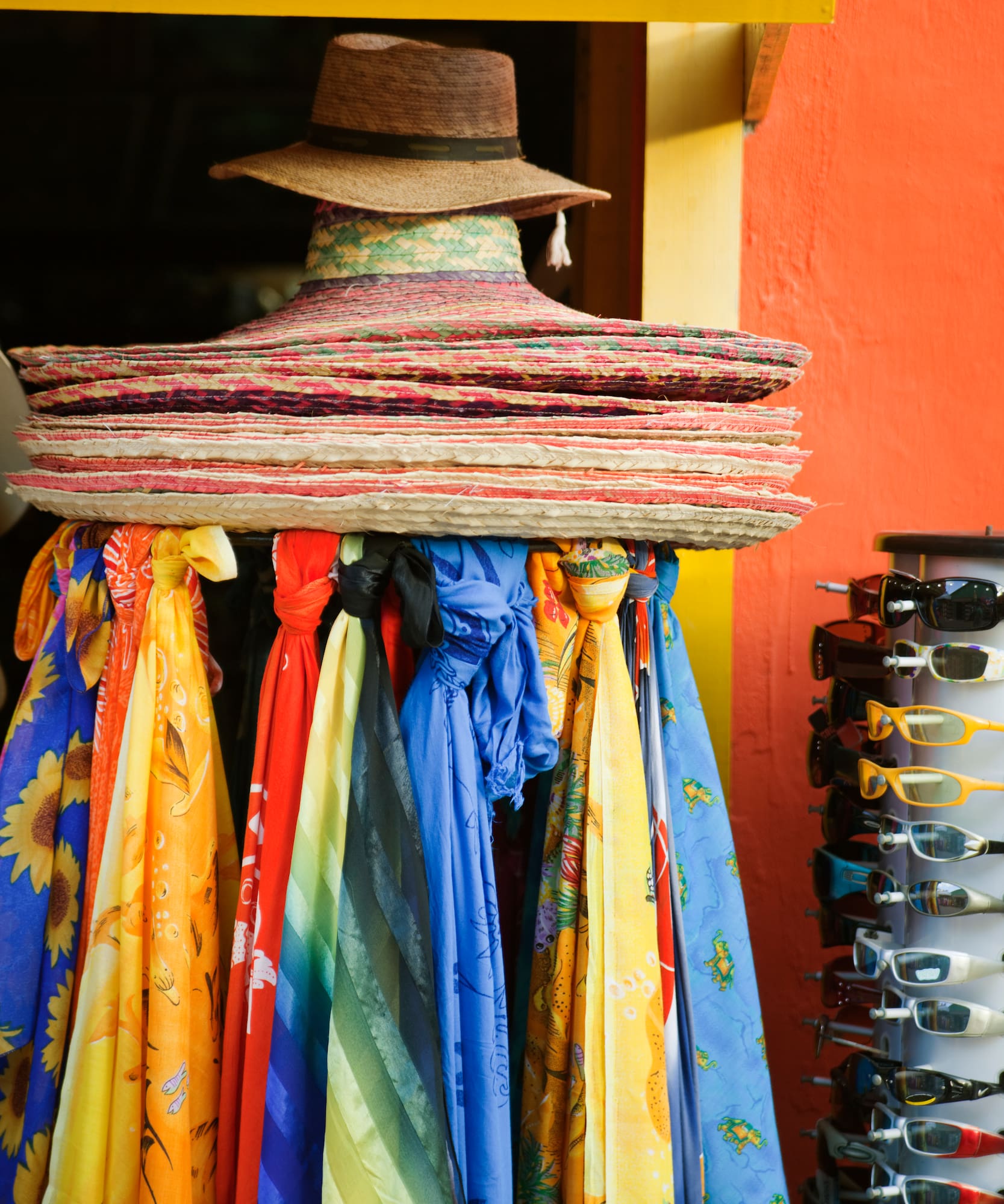 a group of hats and scarves on a rack