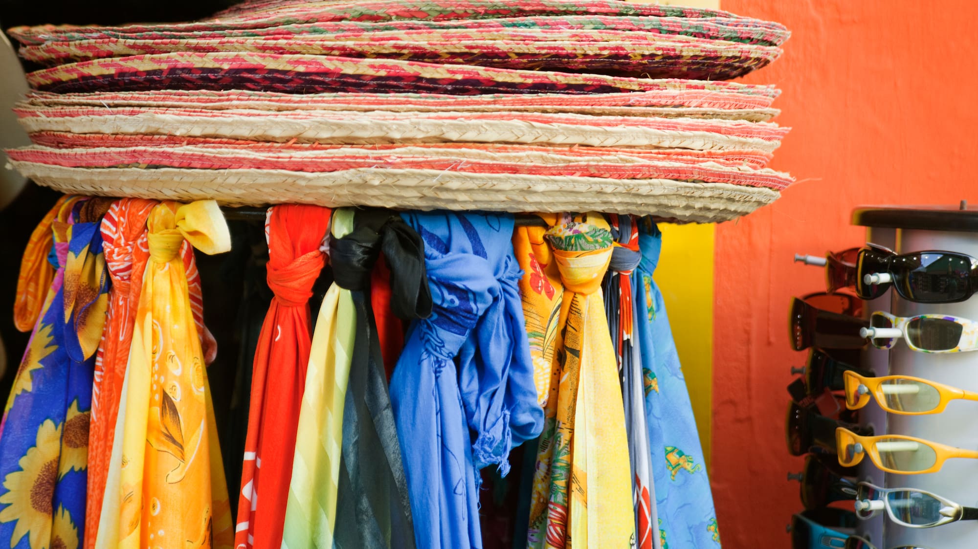 a group of hats and scarves on a rack