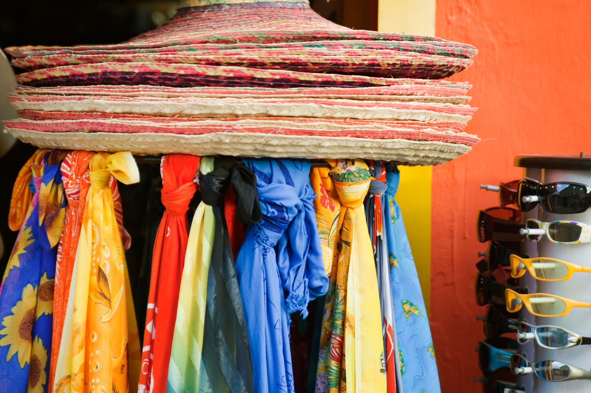 a group of hats and scarves on a rack