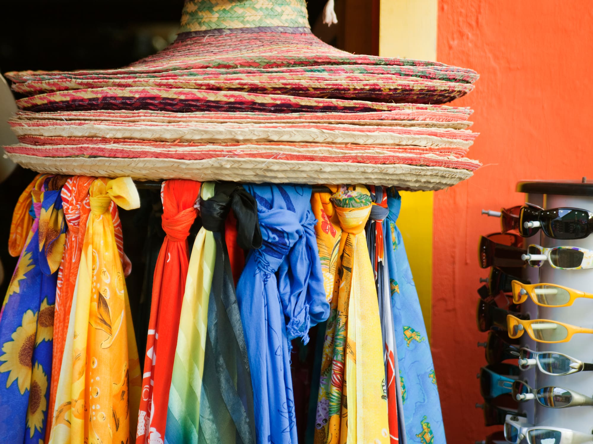 a group of hats and scarves on a rack