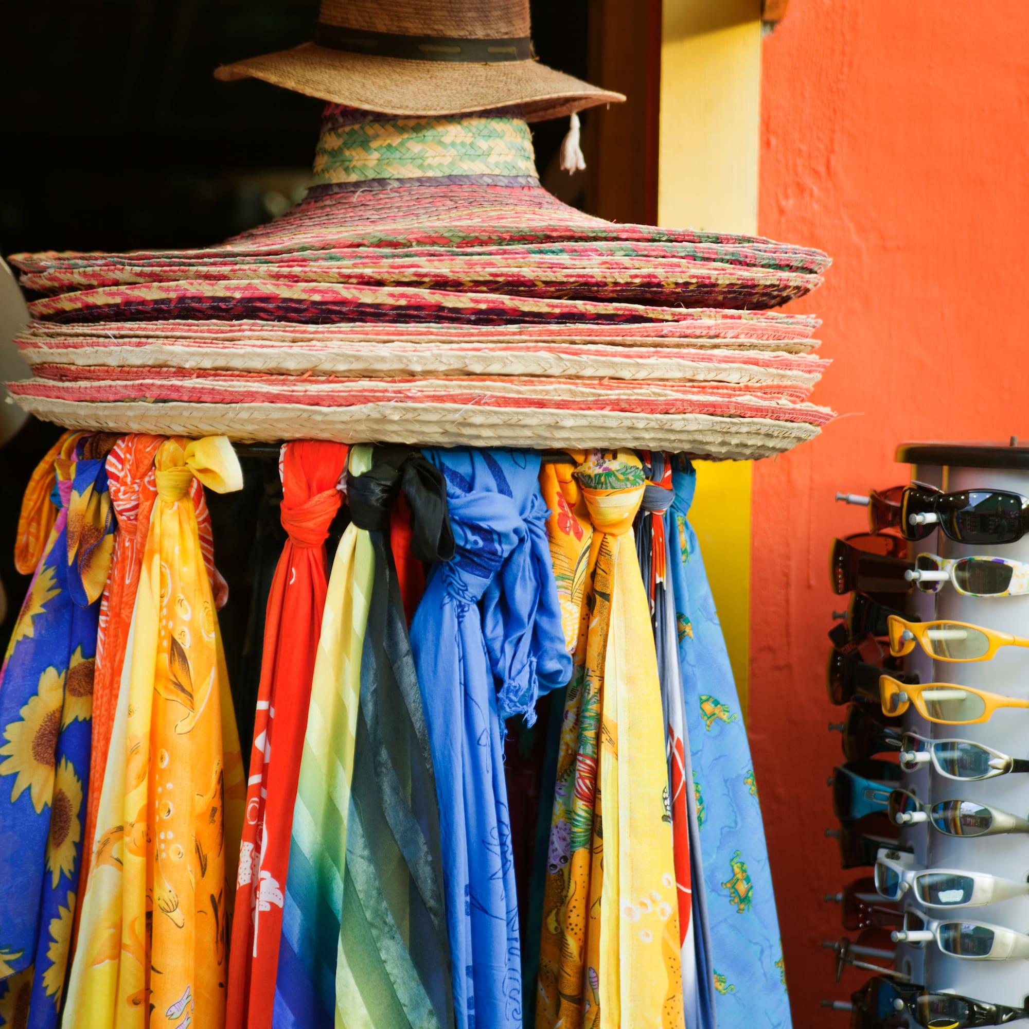 a group of hats and scarves on a rack