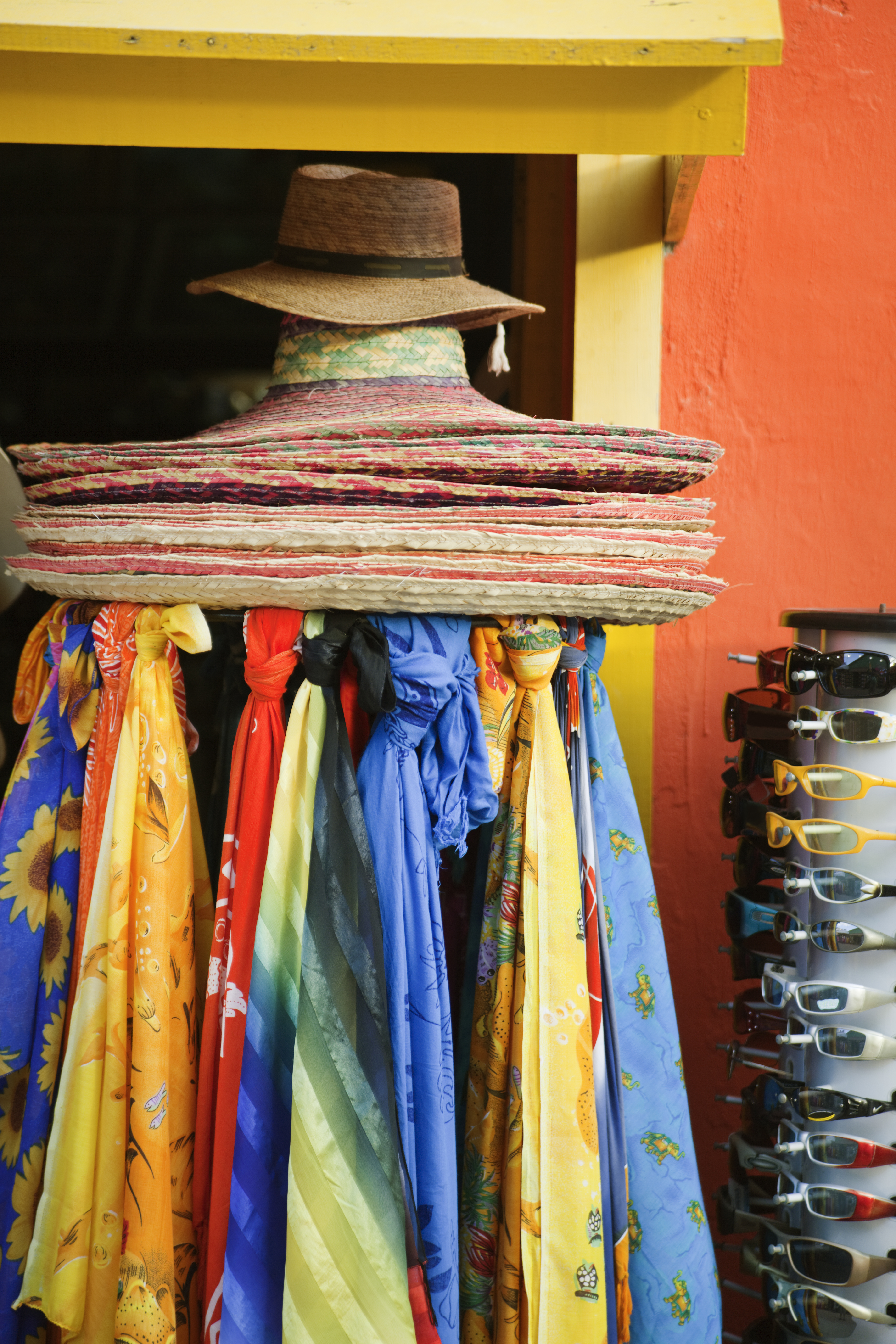 a group of hats and scarves on a rack