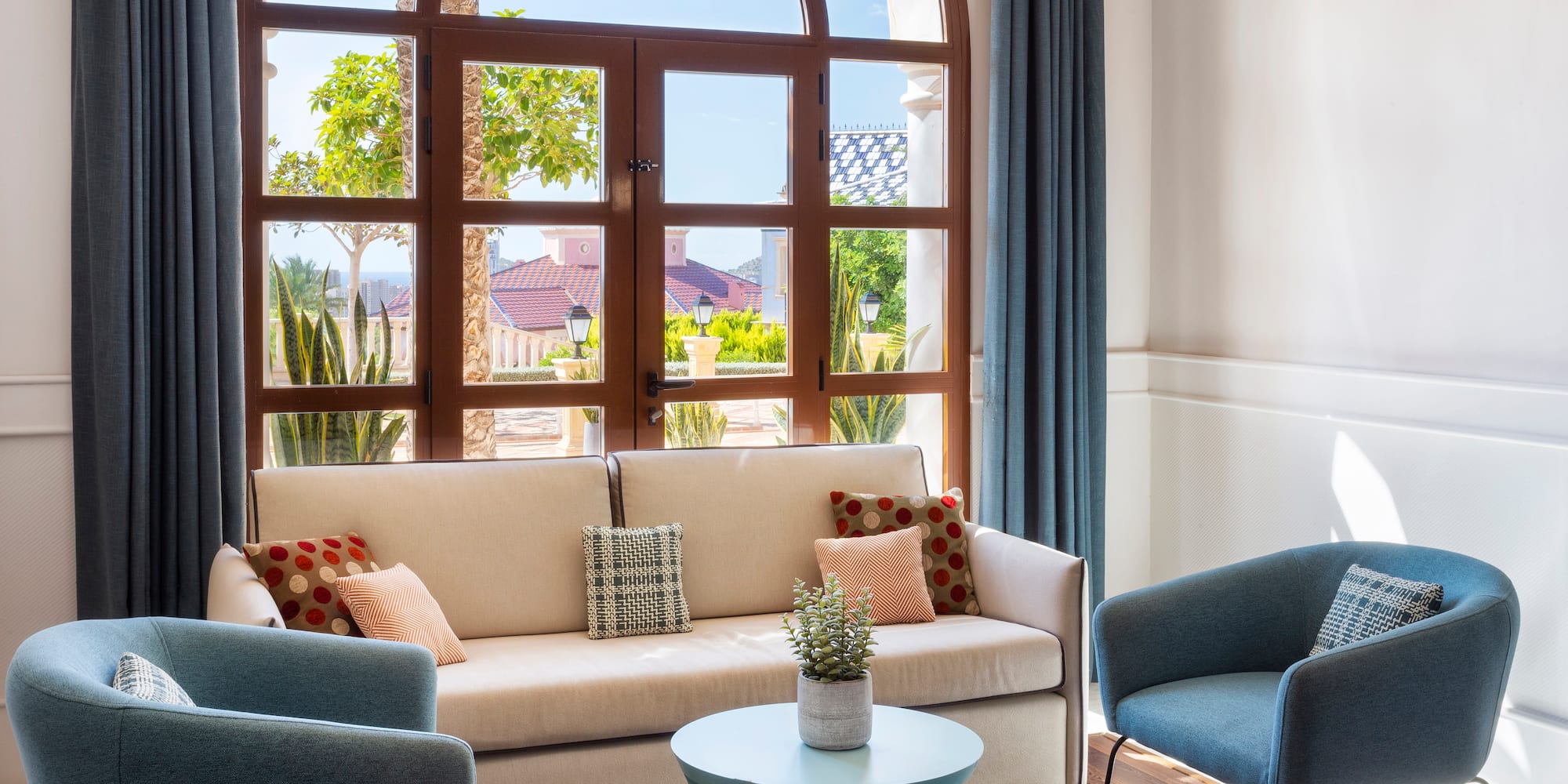 a living room with a couch and chairs