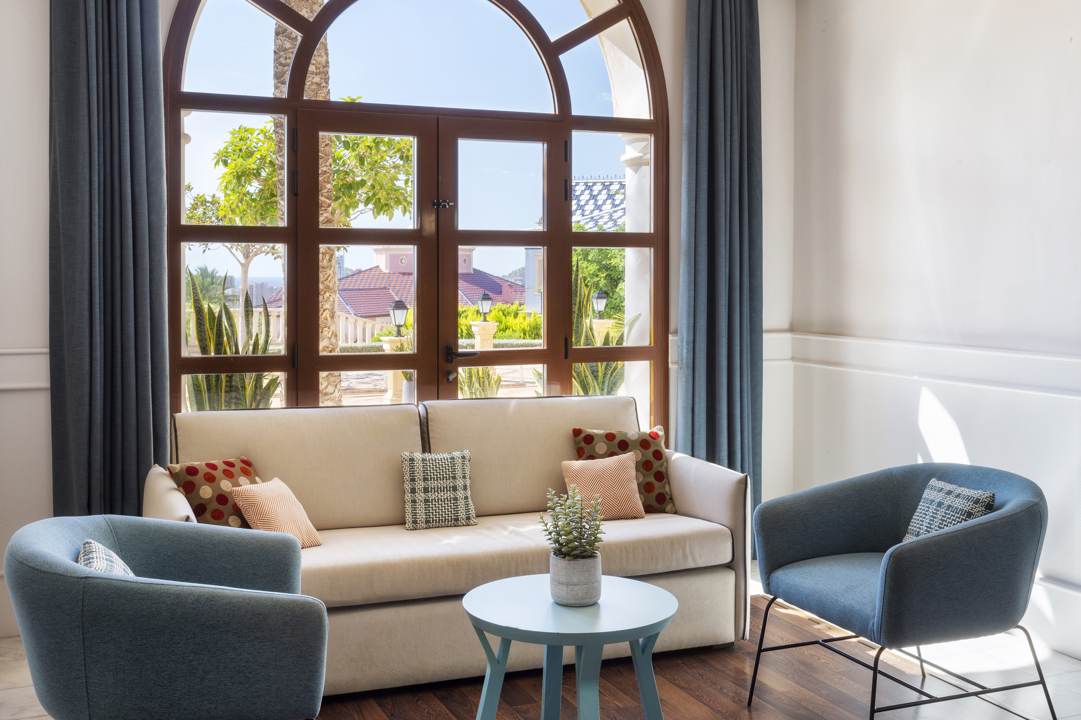 a living room with a couch and chairs
