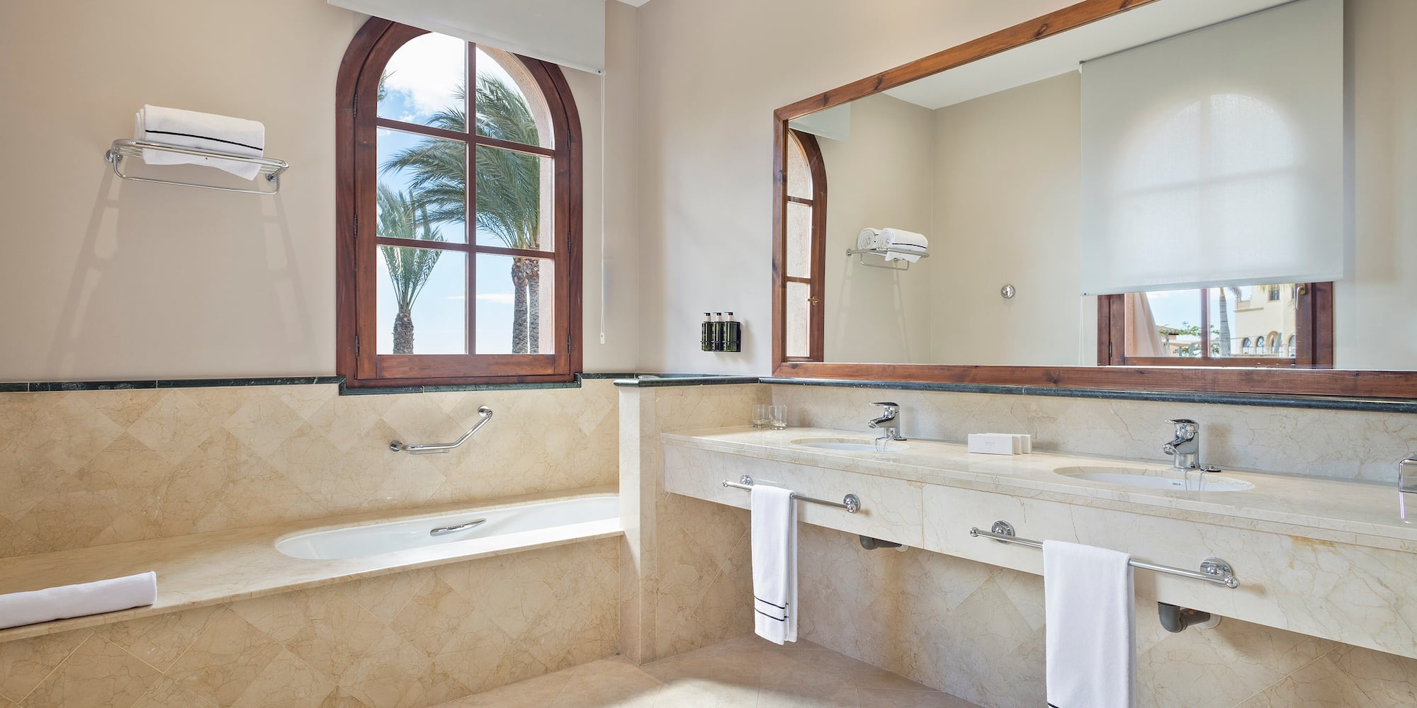a bathroom with a large mirror and two sinks