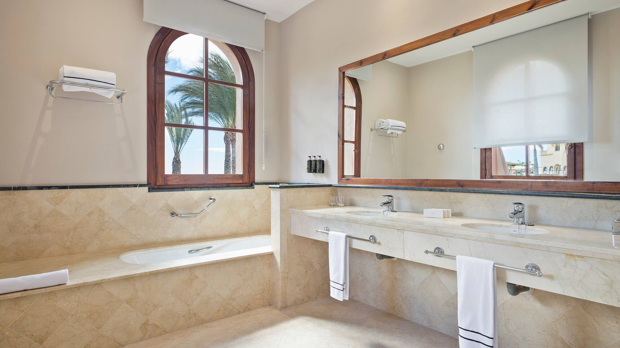 a bathroom with a large mirror and two sinks