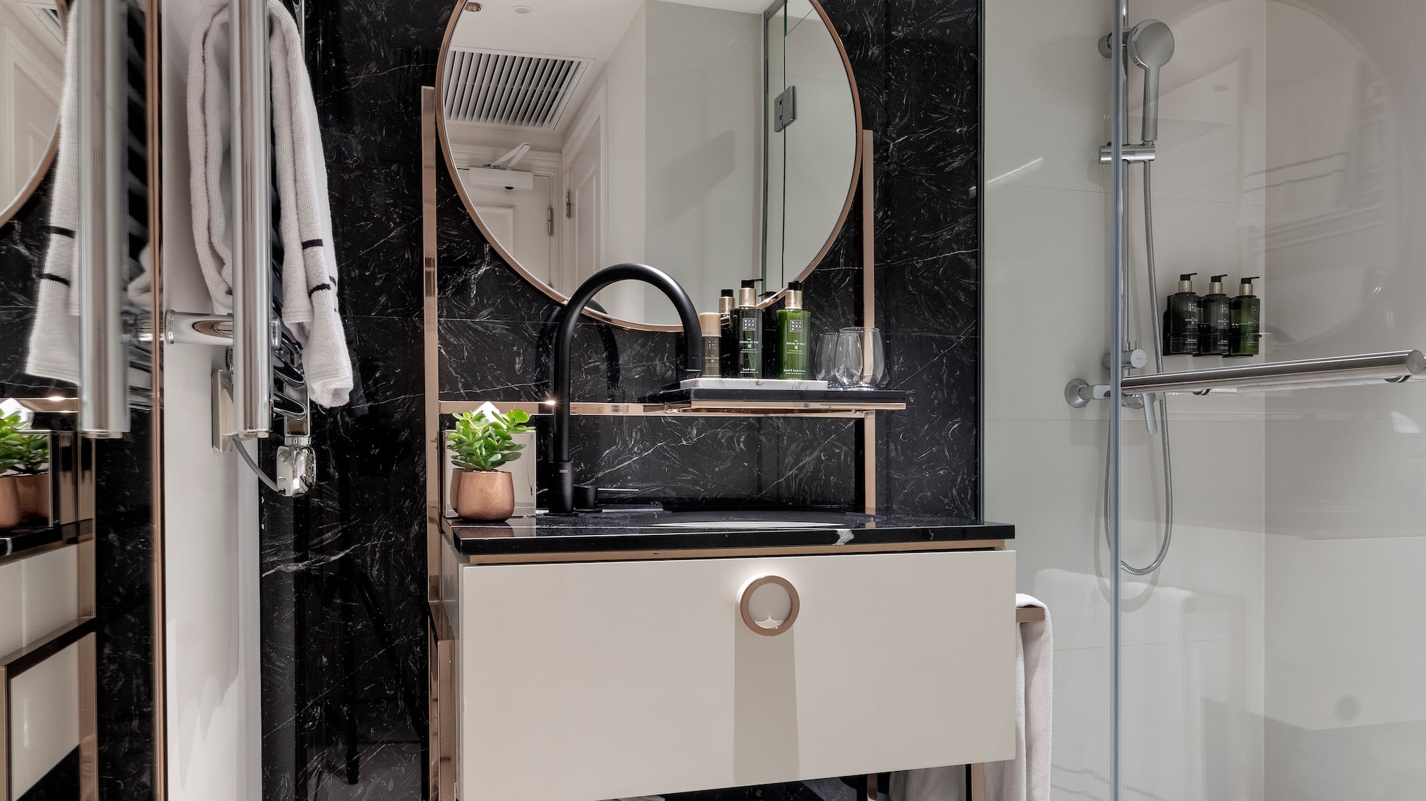 a bathroom with a mirror and shower