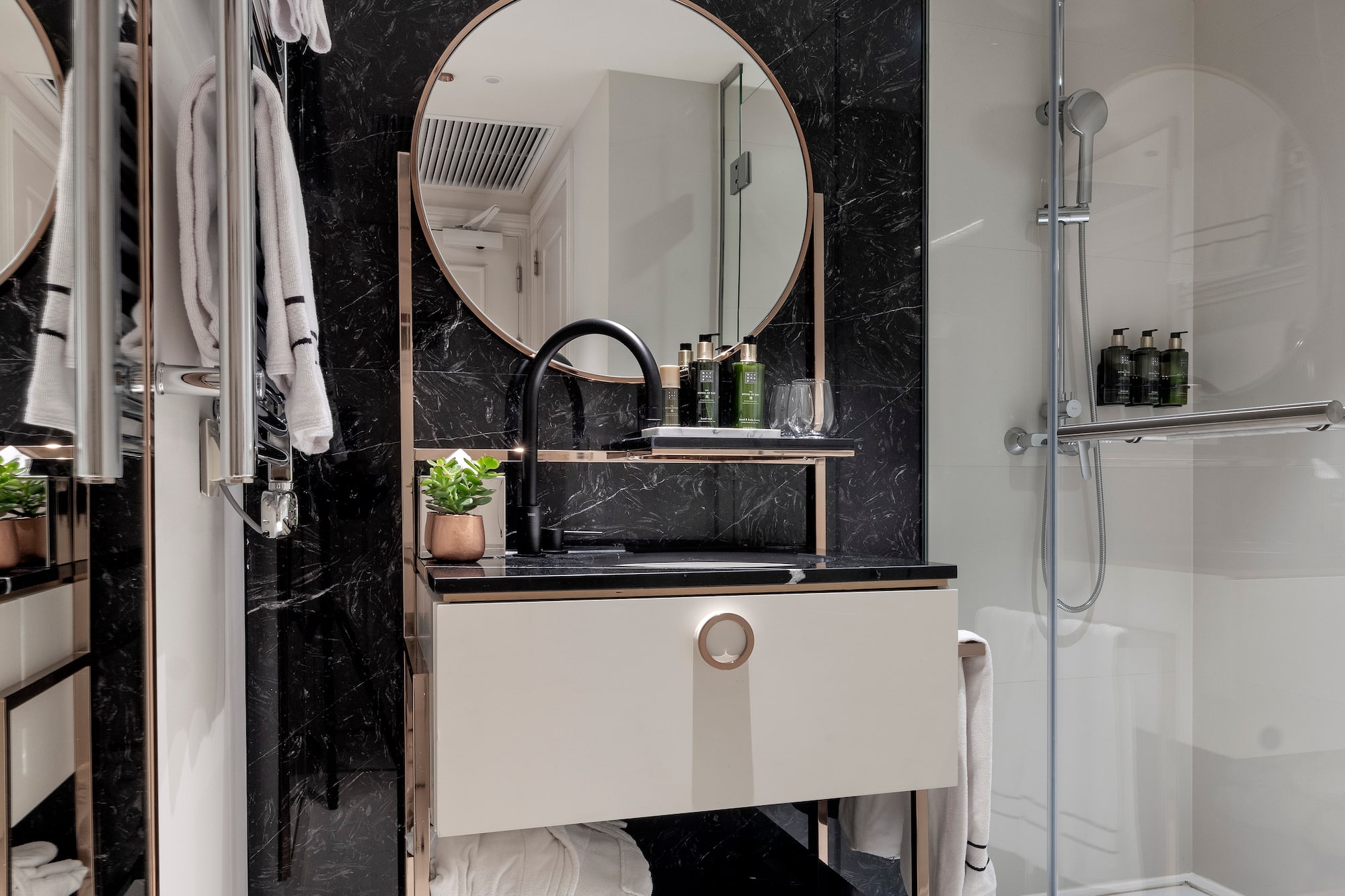 a bathroom with a mirror and shower
