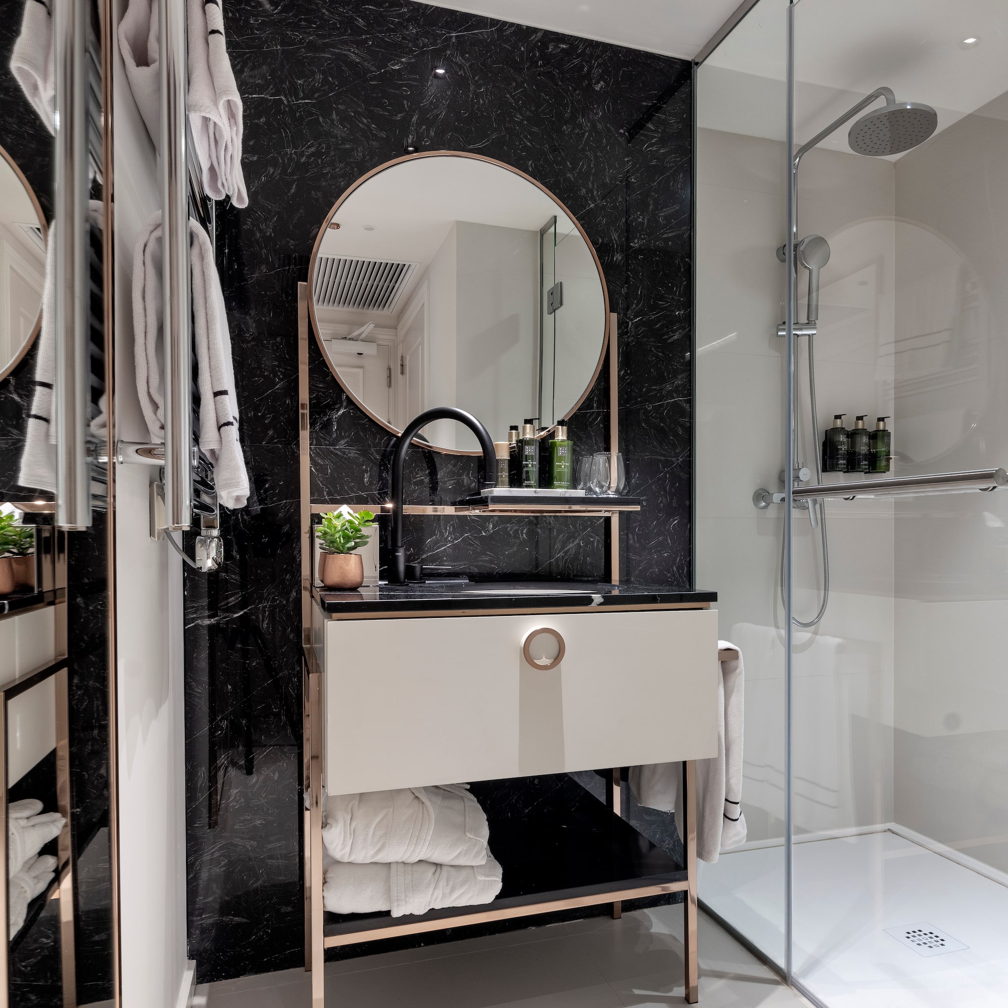 a bathroom with a mirror and shower