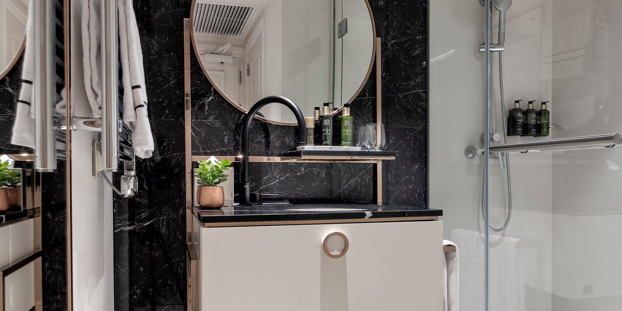 a bathroom with a mirror and shower