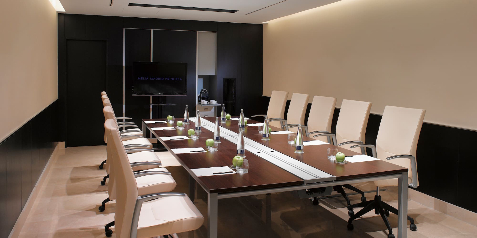 a conference room with a table and chairs