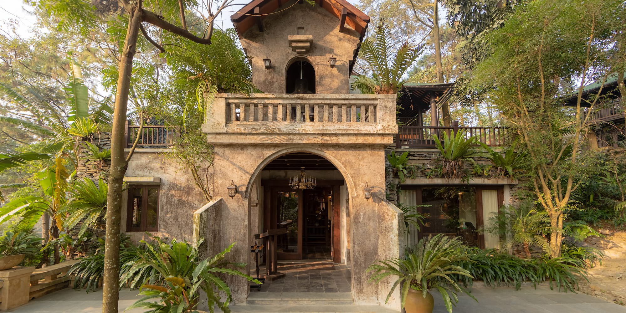 a building with trees and plants around it