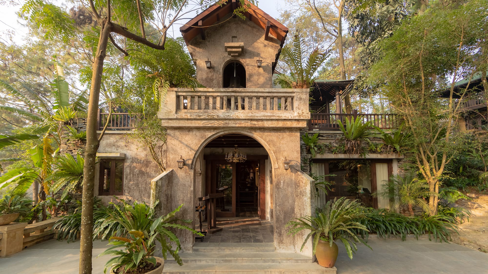 a building with trees and plants around it