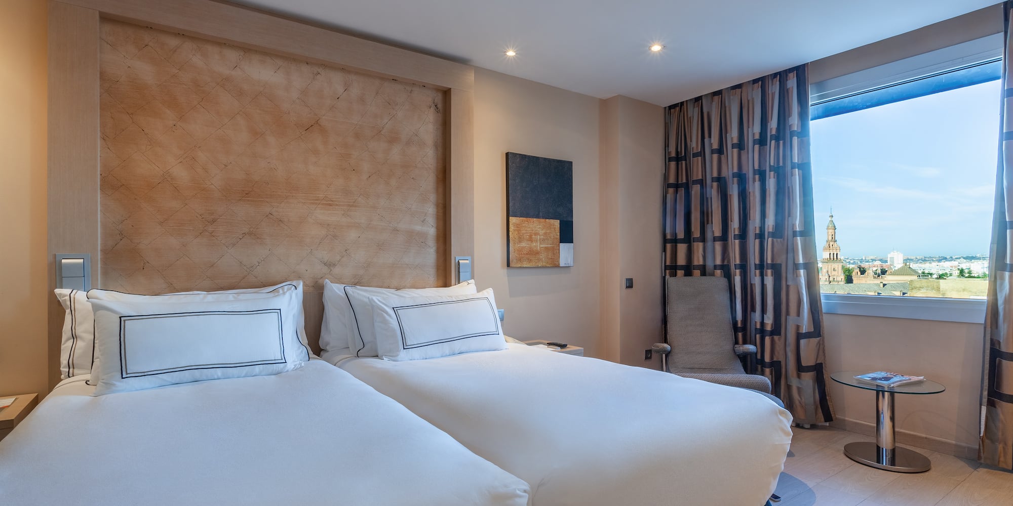 a room with two beds and a window