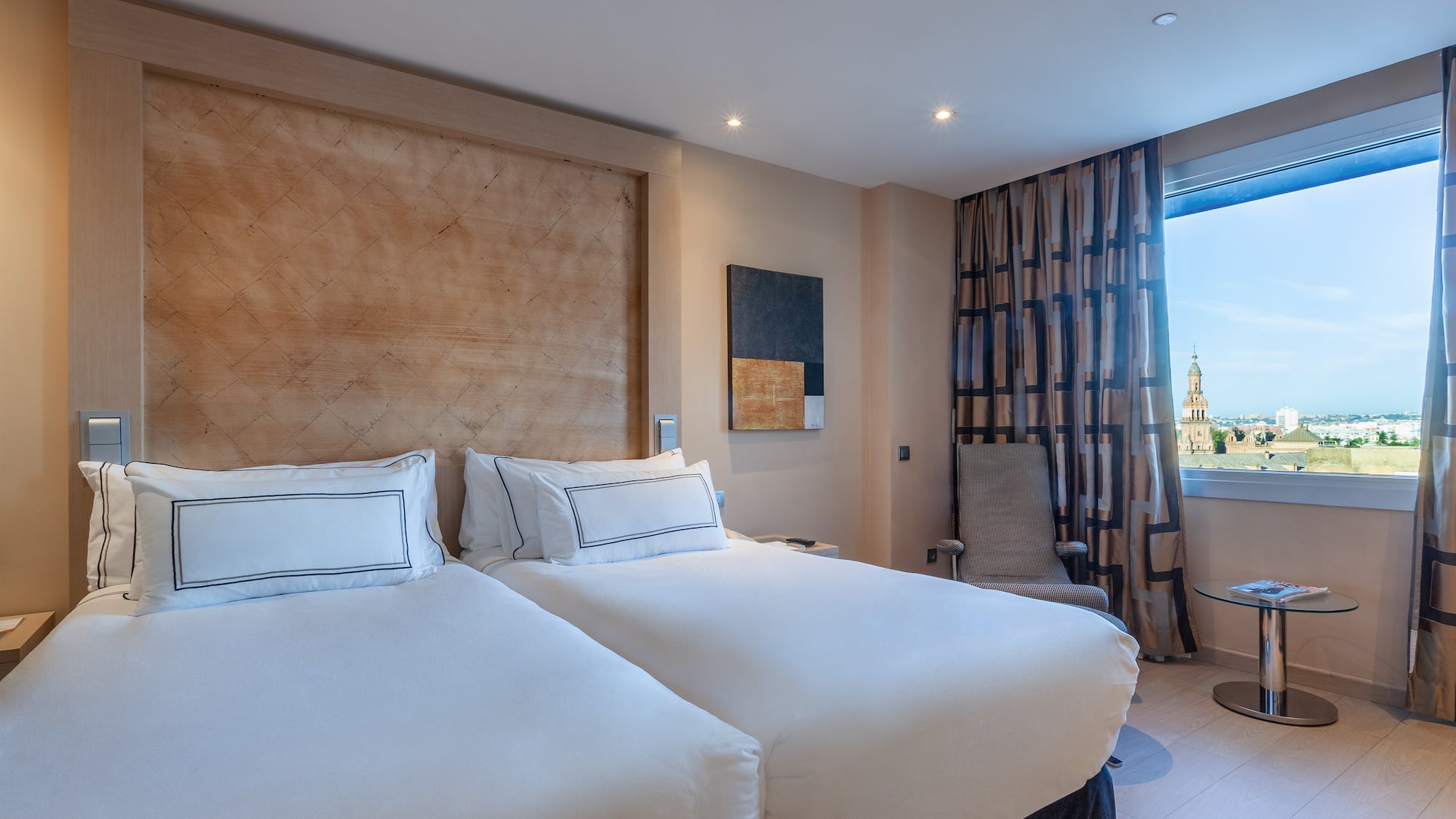 a room with two beds and a window