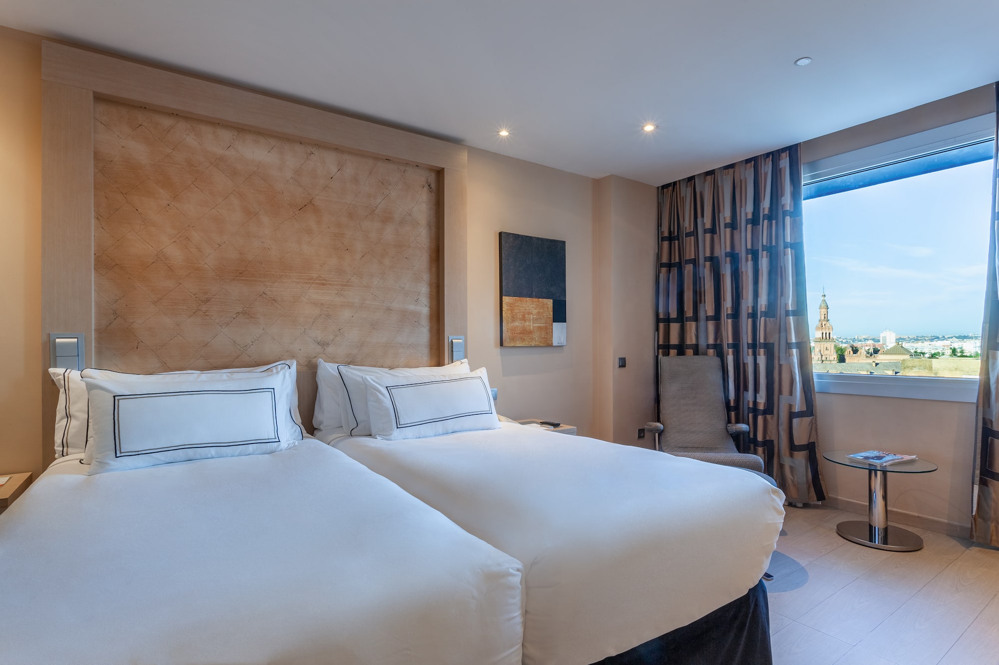 a room with two beds and a window