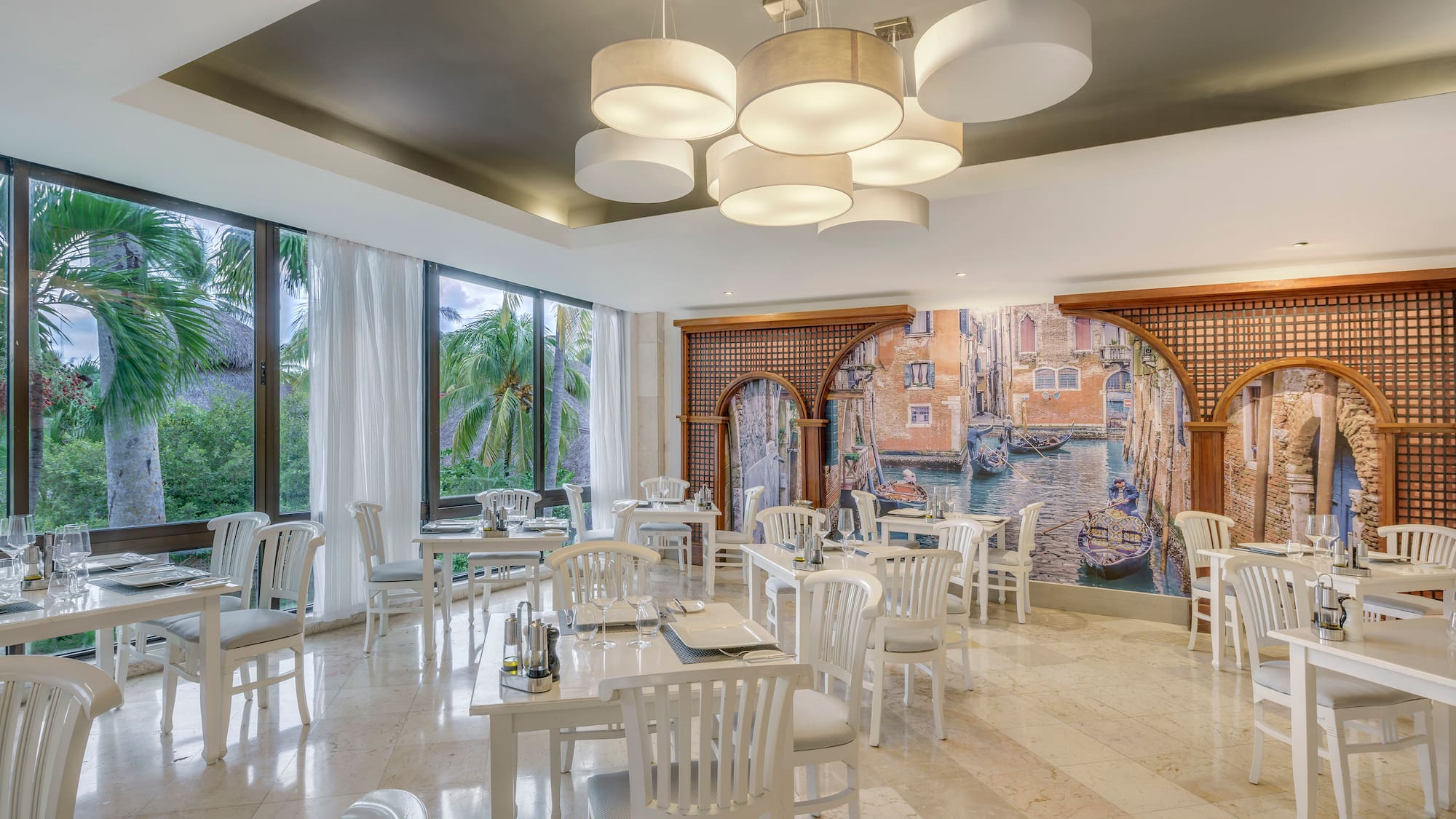 a room with white tables and chairs