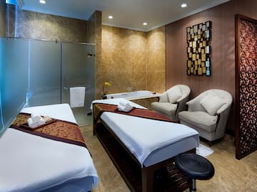 a room with two beds and a tub