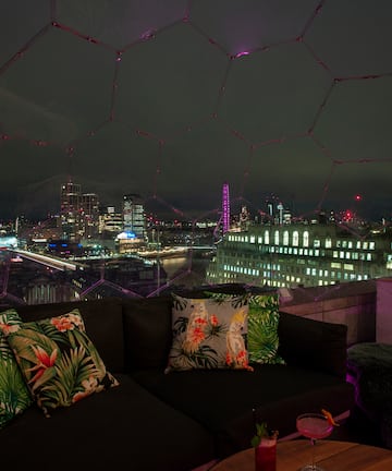 a couch with pillows on it overlooking a city