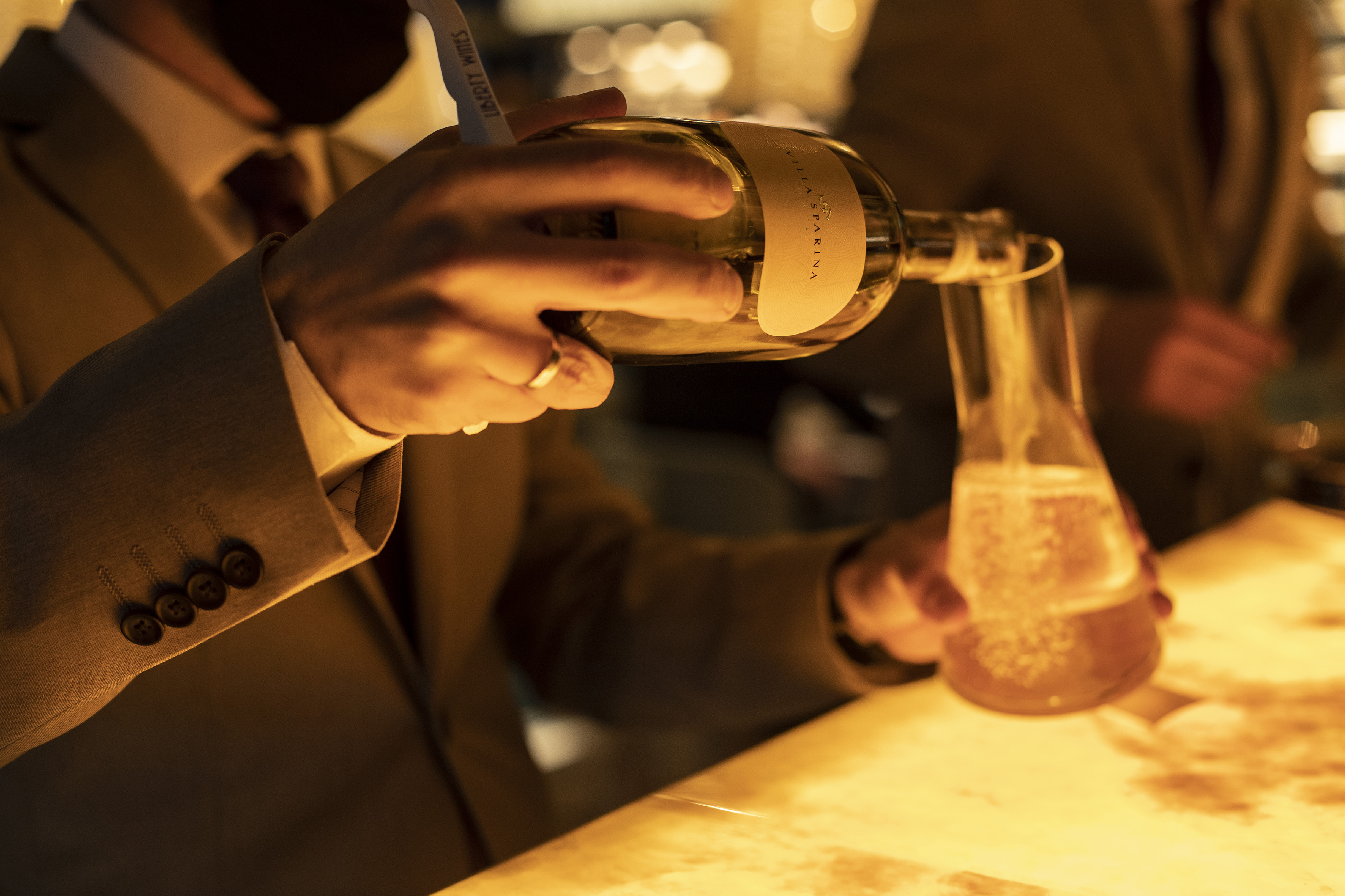 a person pouring liquid into a beaker