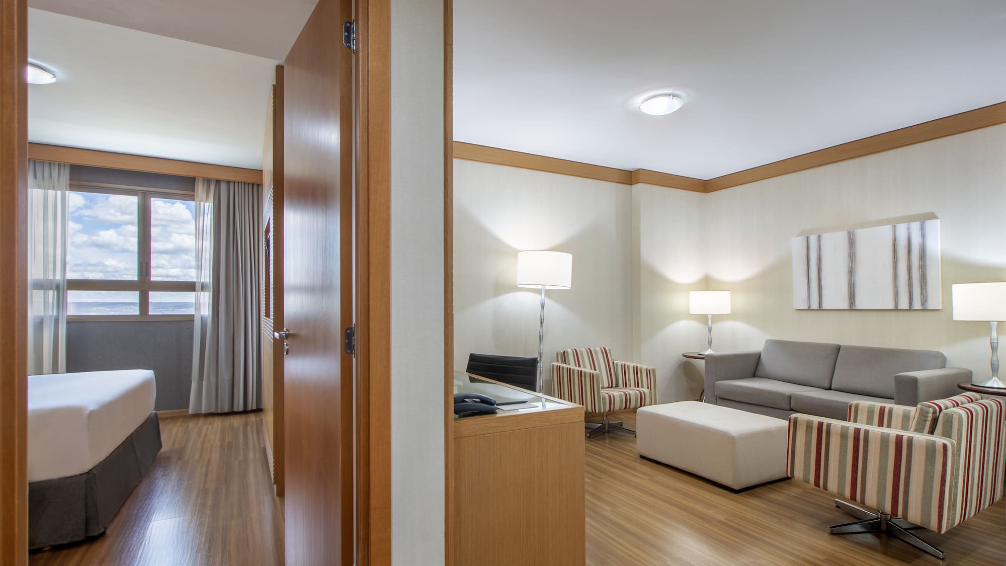 a room with a couch and a couch and a wood floor