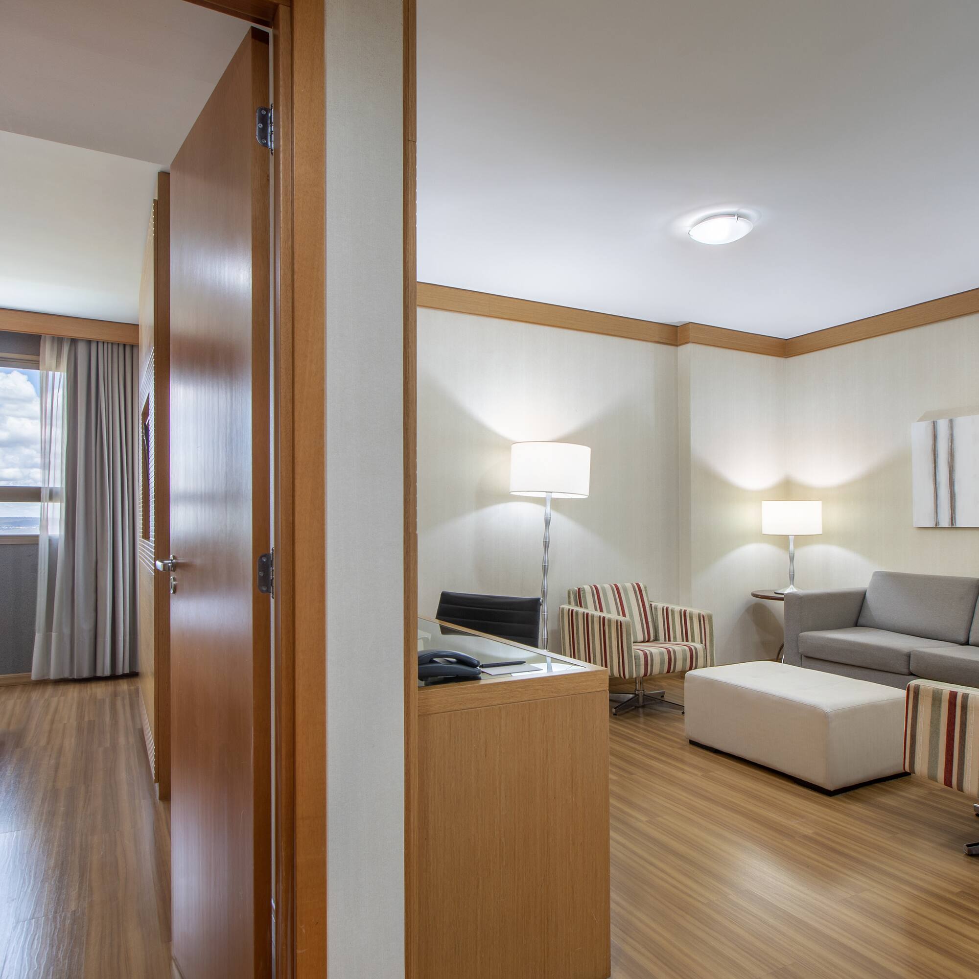 a room with a couch and a couch and a wood floor