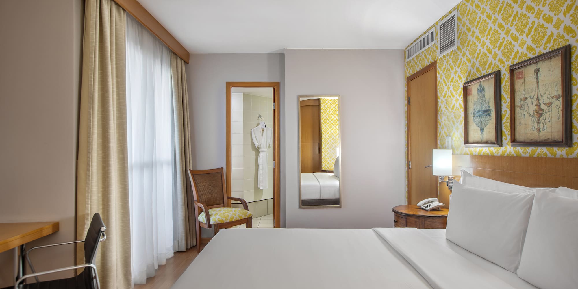 a room with a bed and a mirror