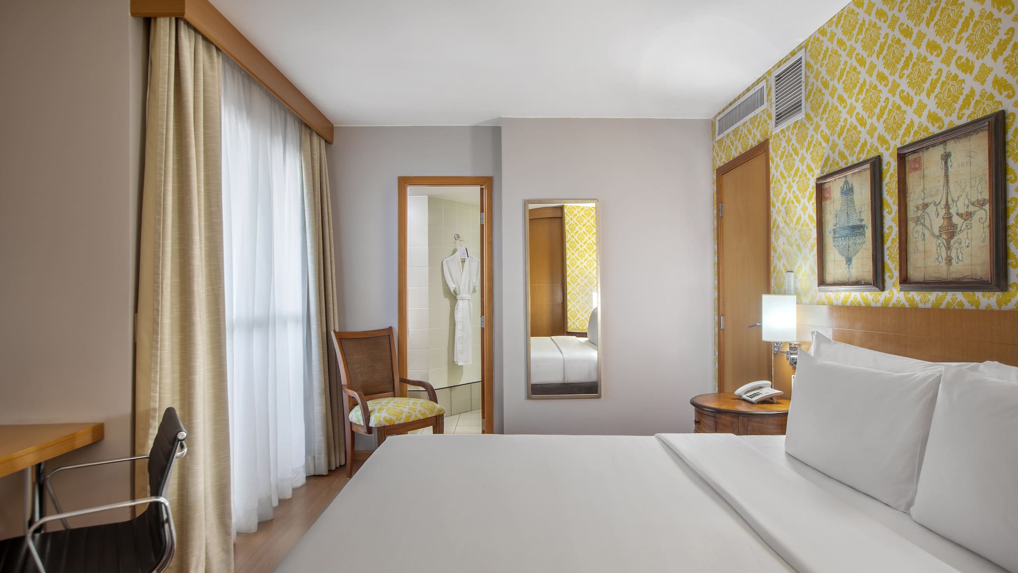 a room with a bed and a mirror