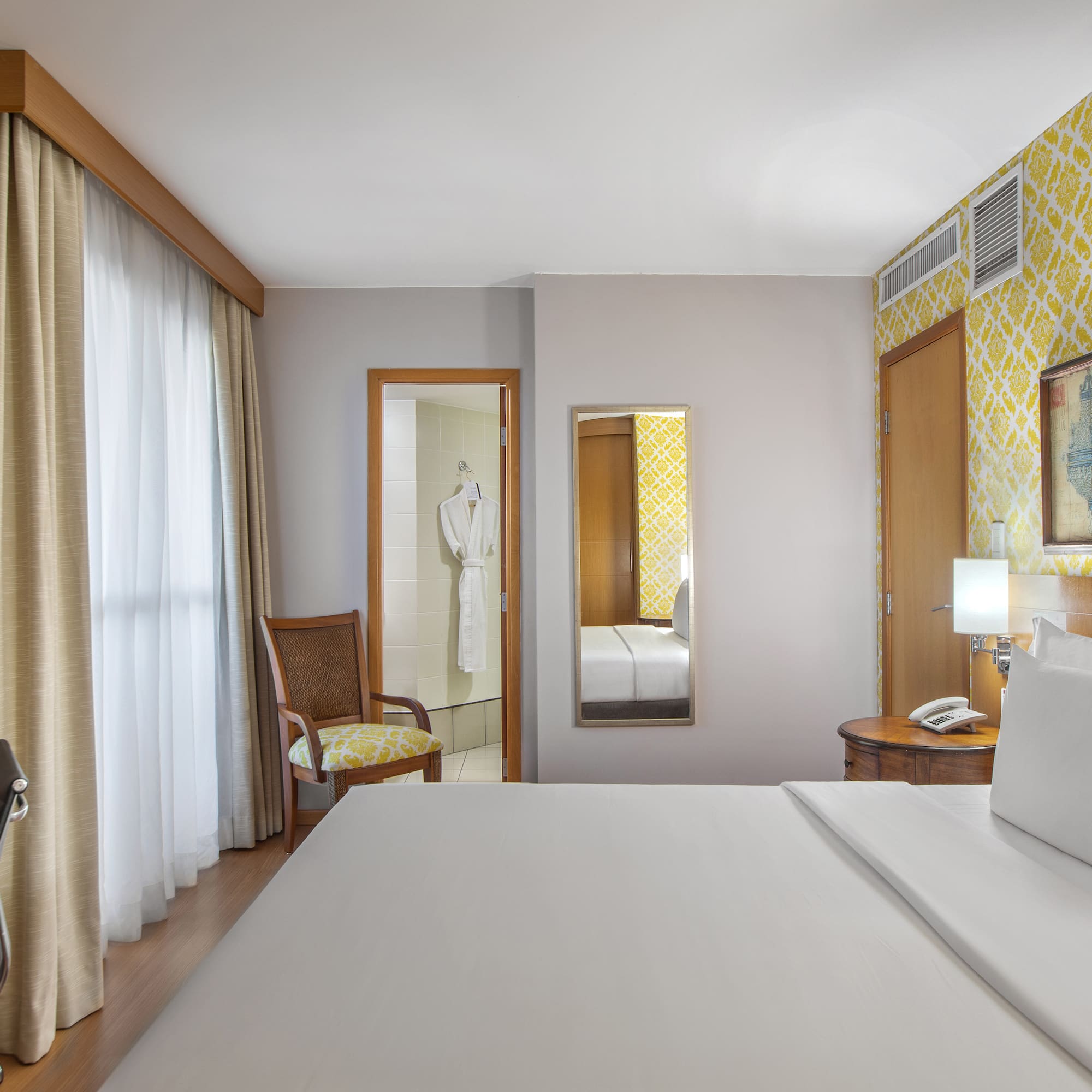 a room with a bed and a mirror