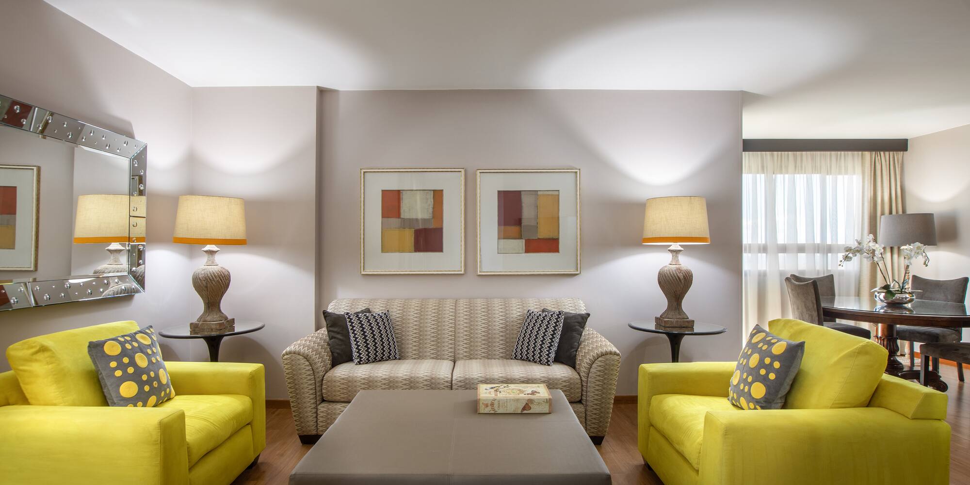 a living room with yellow couches and a coffee table