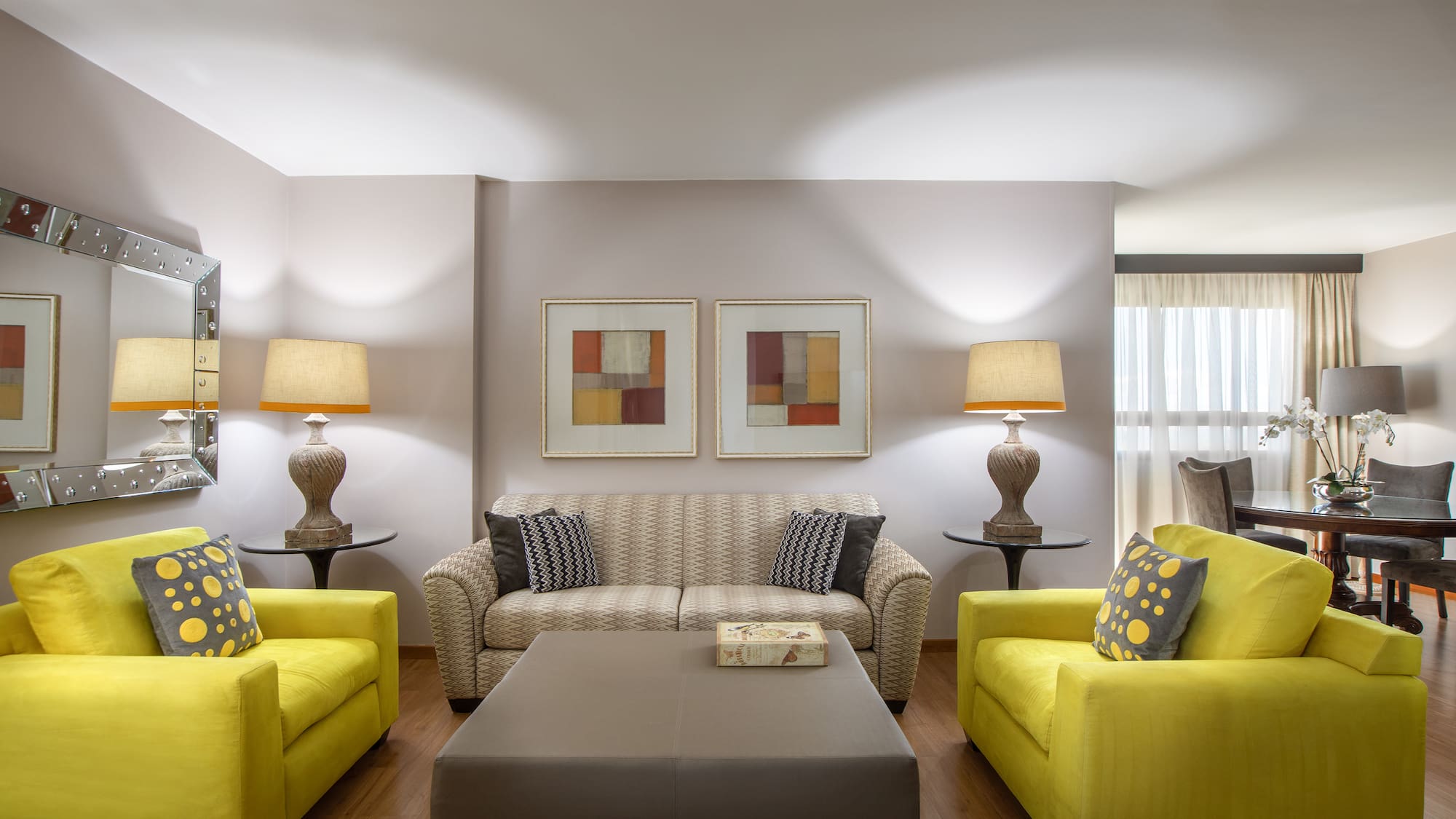 a living room with yellow couches and a coffee table